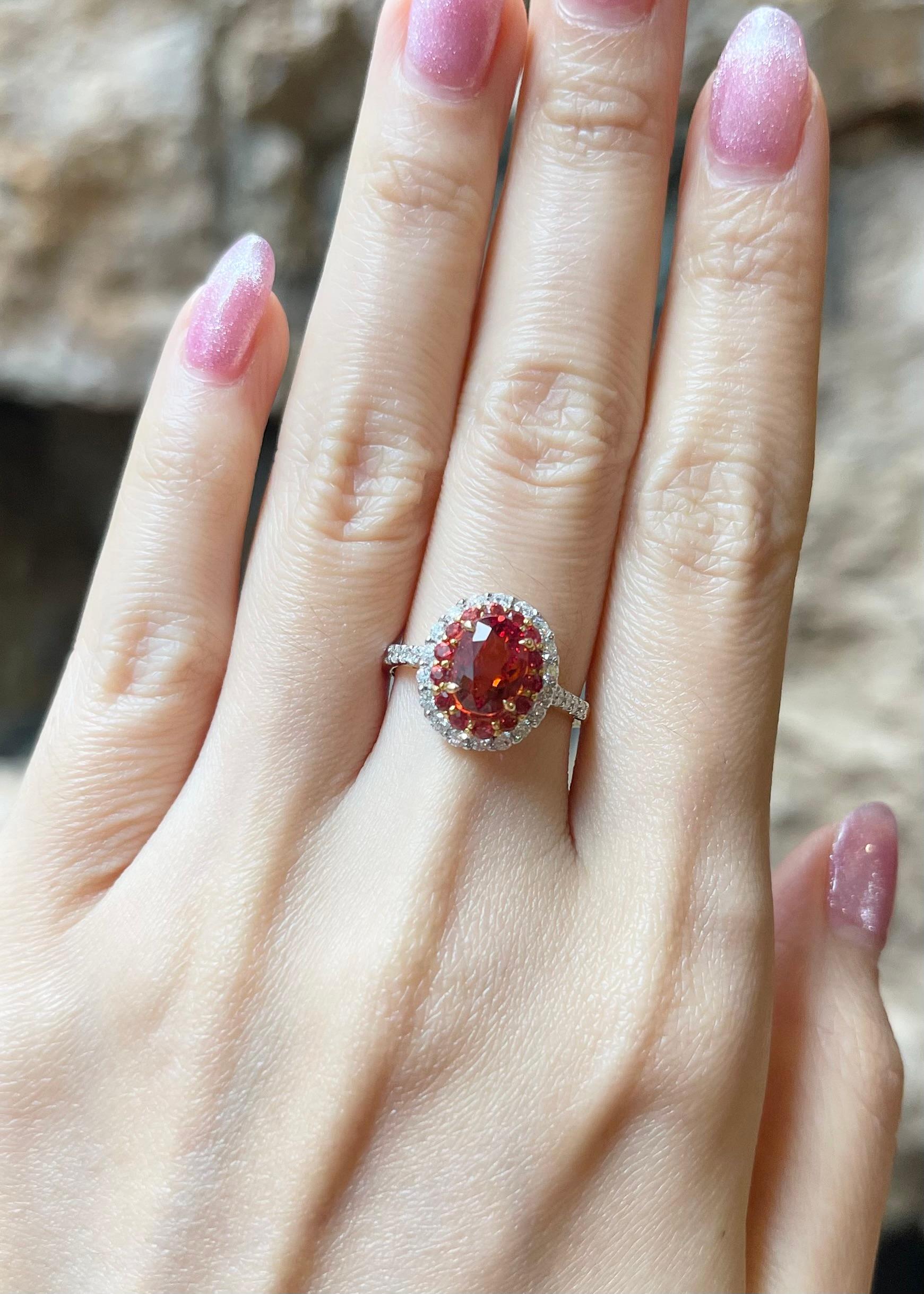 Orange Sapphire 2.04 carats with Orange Sapphire 0.38 carat and Diamond 0.48 carat Ring set in 18K Gold Settings

Width:  1.1 cm 
Length: 1.3 cm
Ring Size: 51
Total Weight: 4.13 grams

