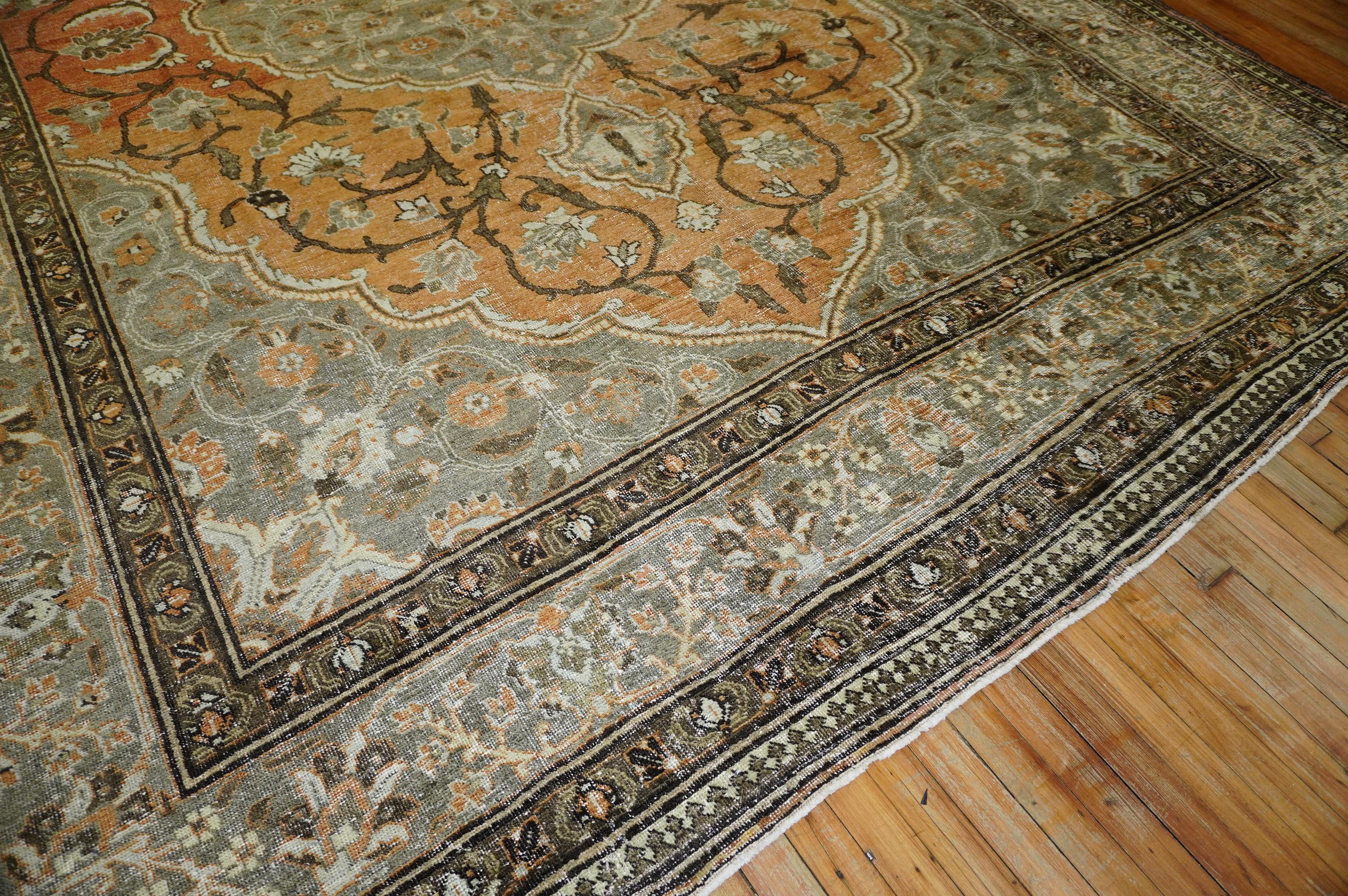 An early 20th century Persian Formal Tabriz rug. Overall even wear throughout in orange and brown.

Measures: 9'6