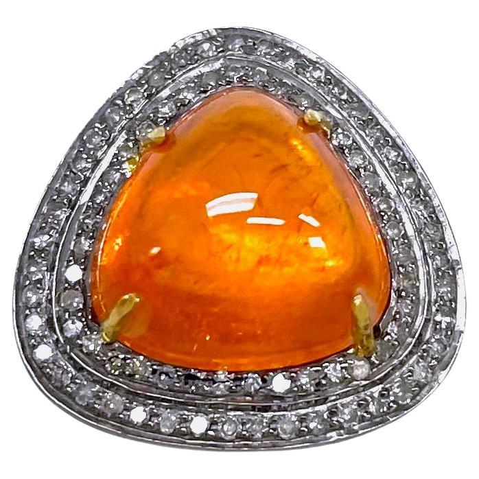 Description
Striking orange color, 13.03 carat sugarloaf cut Spessartite, embellished with pave diamonds. This beautiful Spessartite stone is clear with depth of color, and is enhanced by gray diamonds in a rhodium setting to make a fashionable