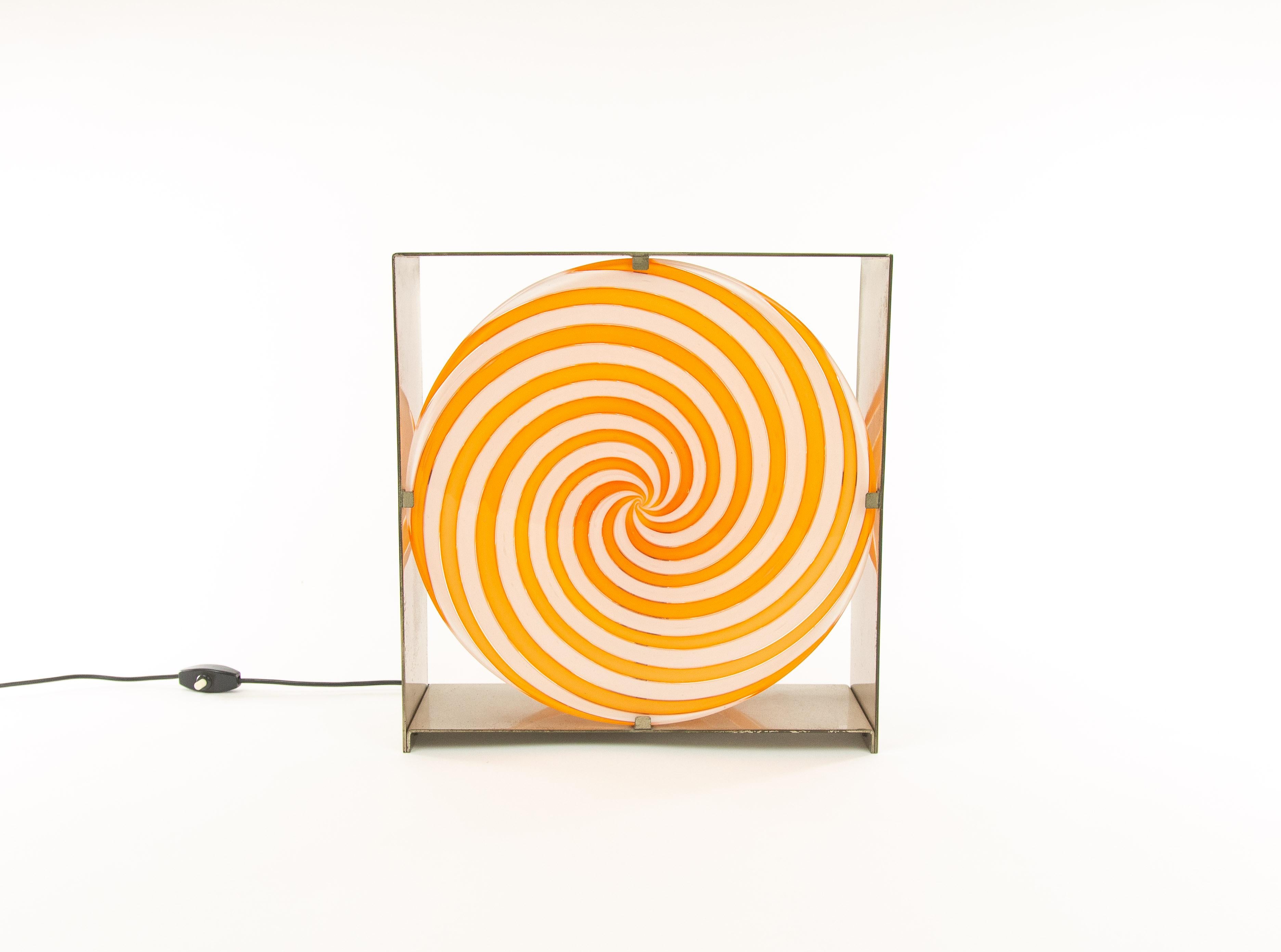 Orange spiral table lamp, model LT 217, by Muranese glass designer Carlo Nason for A.V. Mazzega in the 1960s.

This striking object is made of a nickel-plated brushed metal construction that holds two discs made of Murano glass. The orange spiral