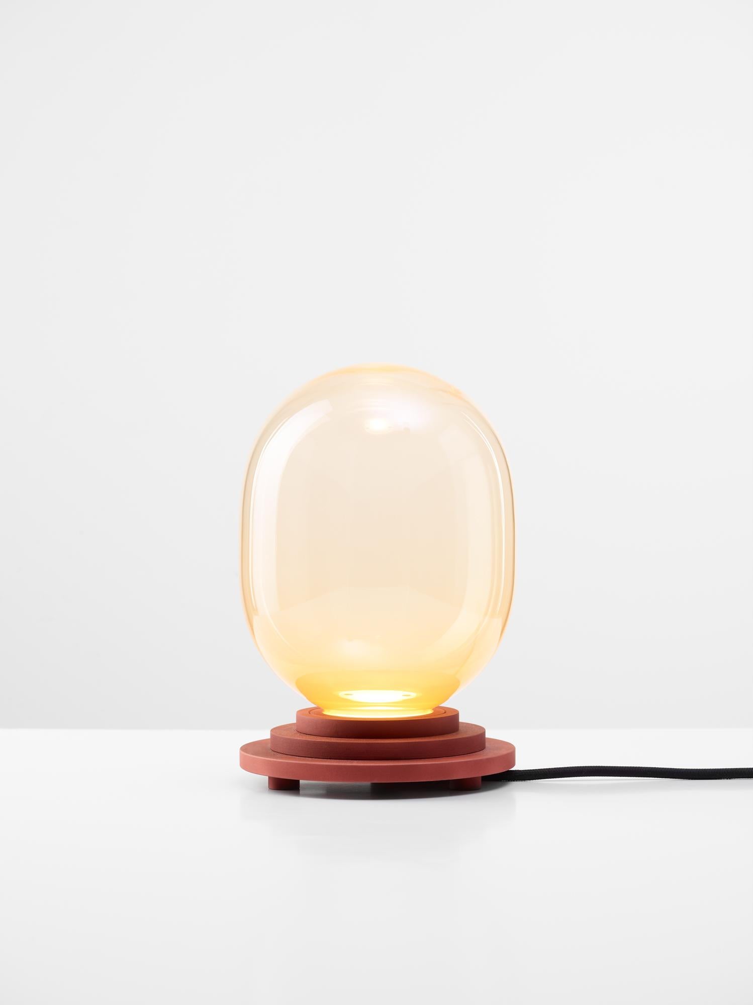Orange Stratos capsule table light by Dechem Studio
Dimensions: D 15 x H 22 cm
Materials: Aluminum, Glass.
Also available: Different colours available

Different shapes of capsules and spheres contrast with anodized alloy fixtures, creating a