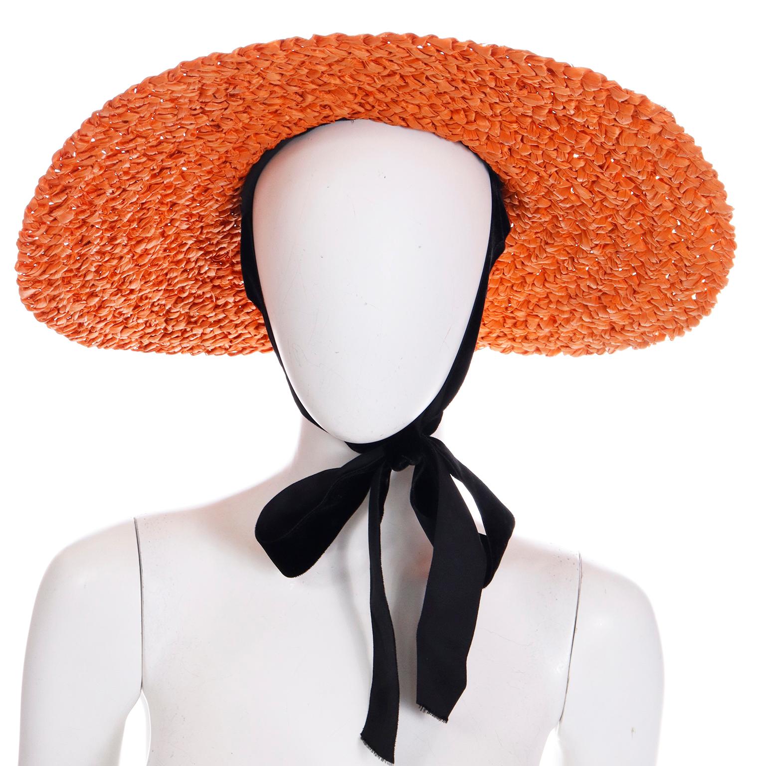 This is such a special vintage late 1930's or early 1940's straw hat from Tailored Woman Fifth Ave at Fifty Seventh Street New York. This fabulous wide brim orange woven straw hat has a pleated black velvet ribbon around the brim with a bow and