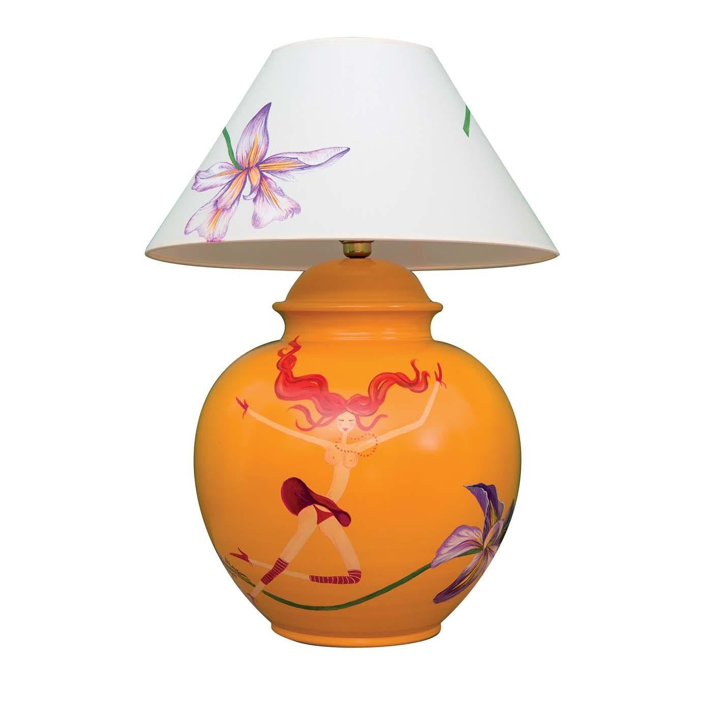 Colorful and refined, this splendid table lamp is composed of a base handcrafted of orange-lacquered clay and a lampshade in white fabric with large hand painted white lilies. Perfectly suited for an eclectic and modern interior, the body is painted