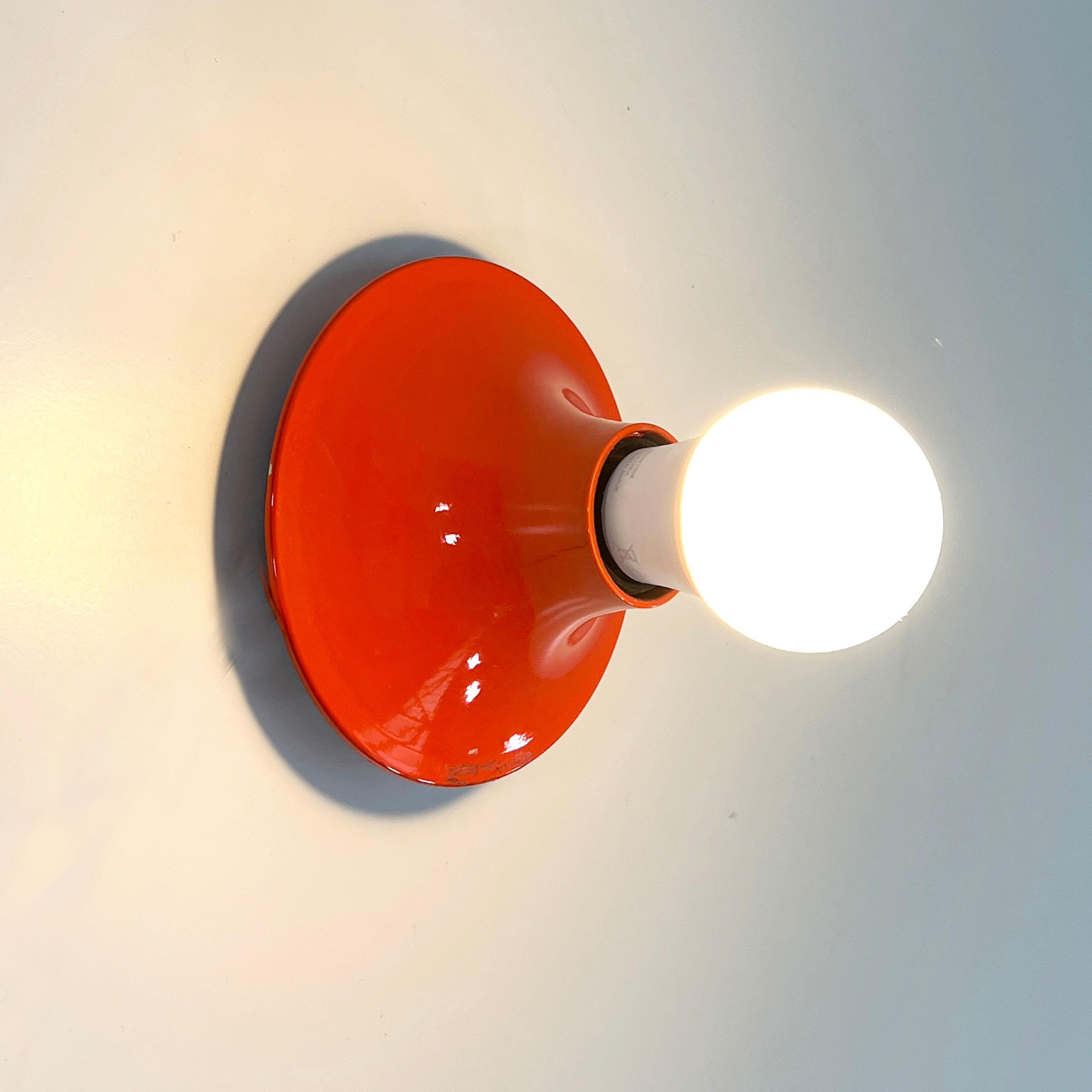 Designer - Vico Magistretti
Producer - Artemide
Model - “Teti” Wall Lamp 
Design Period - Sixties
Measurements - Width 7 cm x Depth 7 cm x Height 14 cm
Materials - Plastic
Color - Orange
Light wear consistent with age and use.