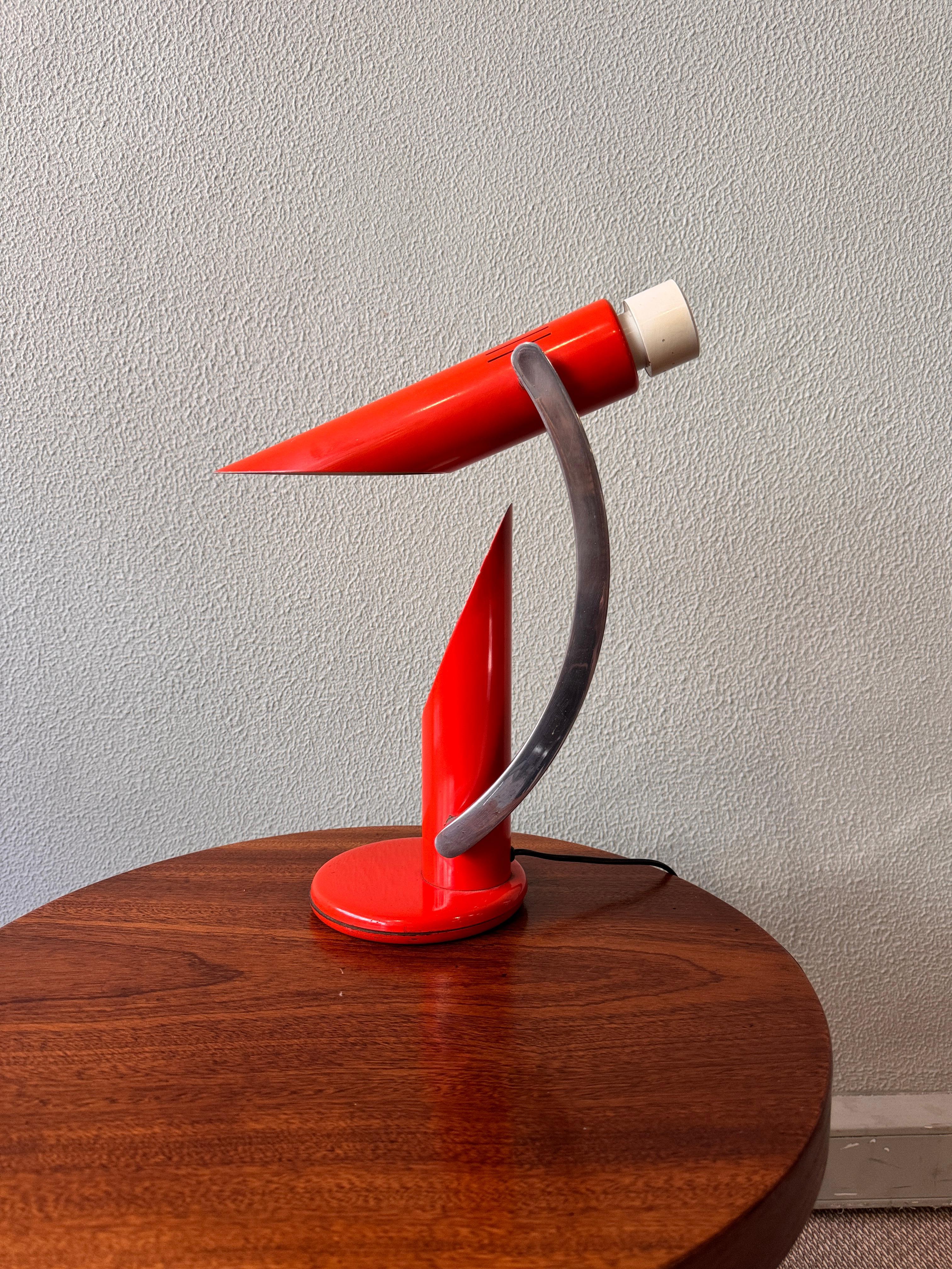 The Tharsis Foldable Table Lamp, designed by Luis Pérez de la Oliva and produced by Fase in 1973, is an exceptional piece of mid-century Spanish design. This model is notable for its dynamic and sculptural form, and the bright orange color adds a