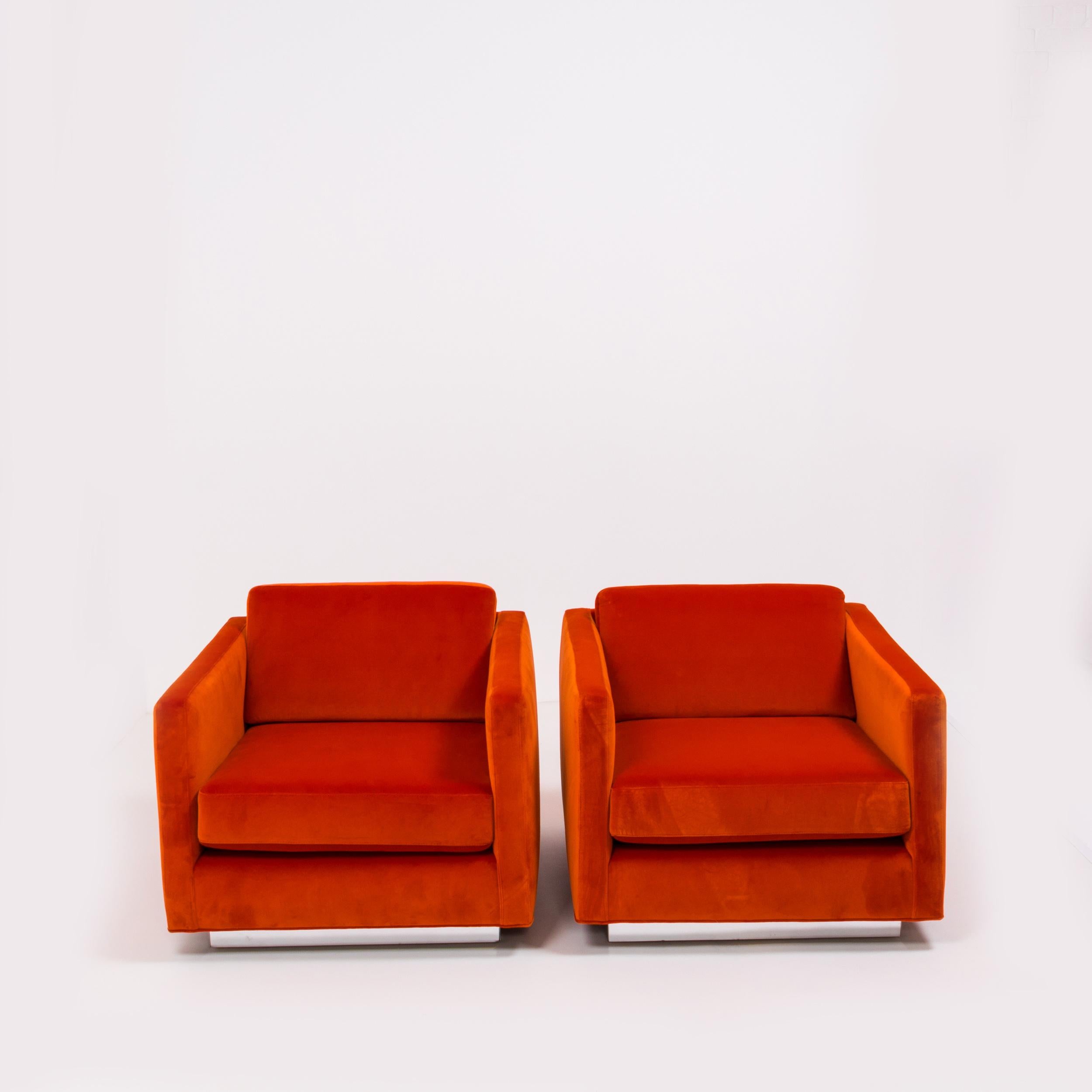 Bright and bold, these exceptional Milo Baughman midcentury cube armchairs combine comfort with a minimalist futuristic aesthetic.

Recently restored, the chairs have been reupholstered in a very vibrant, plush orange velvet and the chrome has