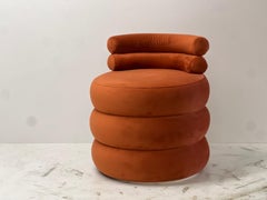 orange velvet rounded puff lounge chair, sculptural and contemporary low seat