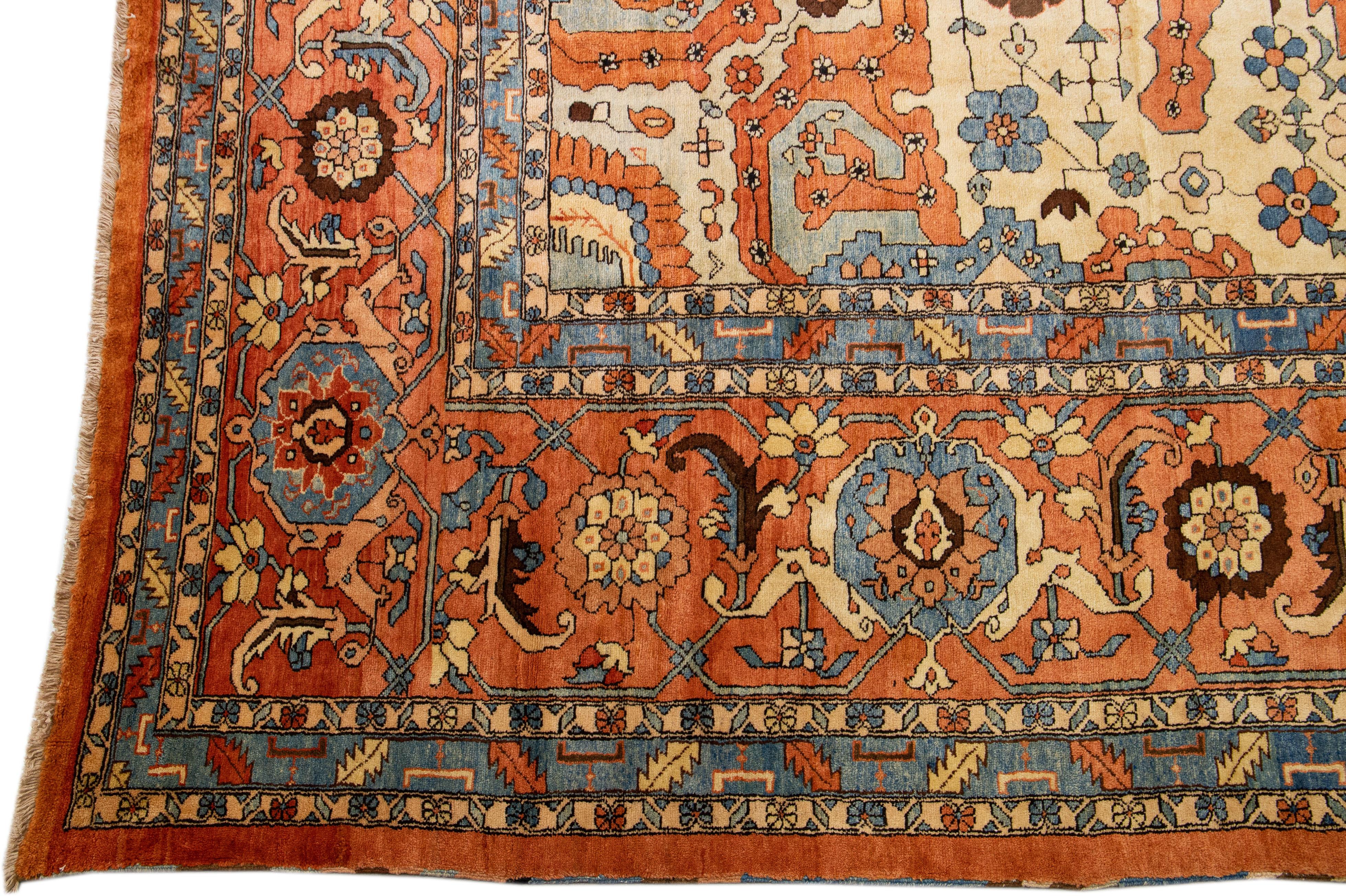 Beautiful antique Heriz hand-knotted wool rug with an orange rust color field. This Persian rug has blue and beige accents in a gorgeous center medallion floral design.

This rug measures: 18'6