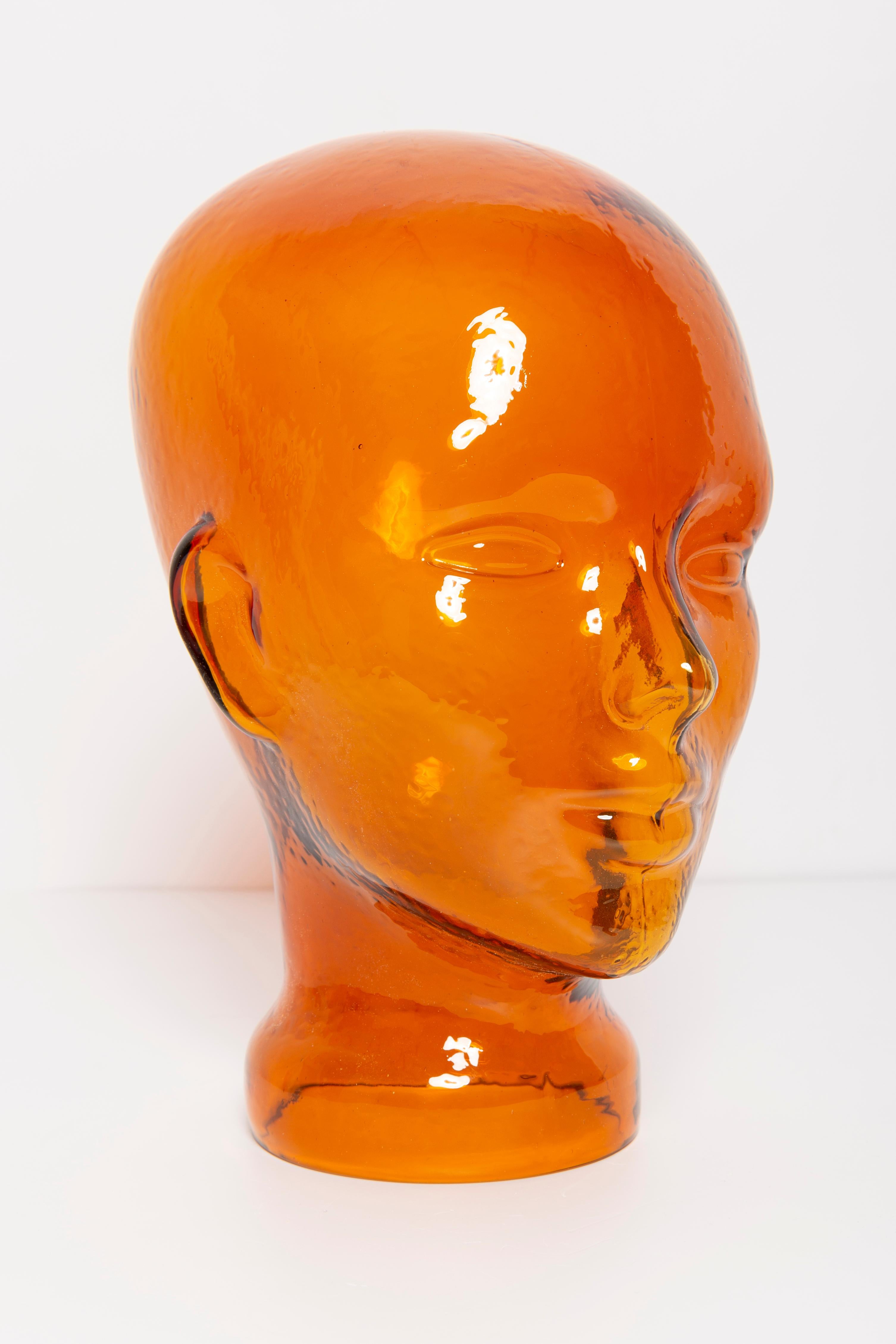 Life-size glass head in a unique beautiful orange color. Produced in a German steelworks in the 1970s. Perfect condition. A perfect addition to the interior, photo prop, display or headphone stand.