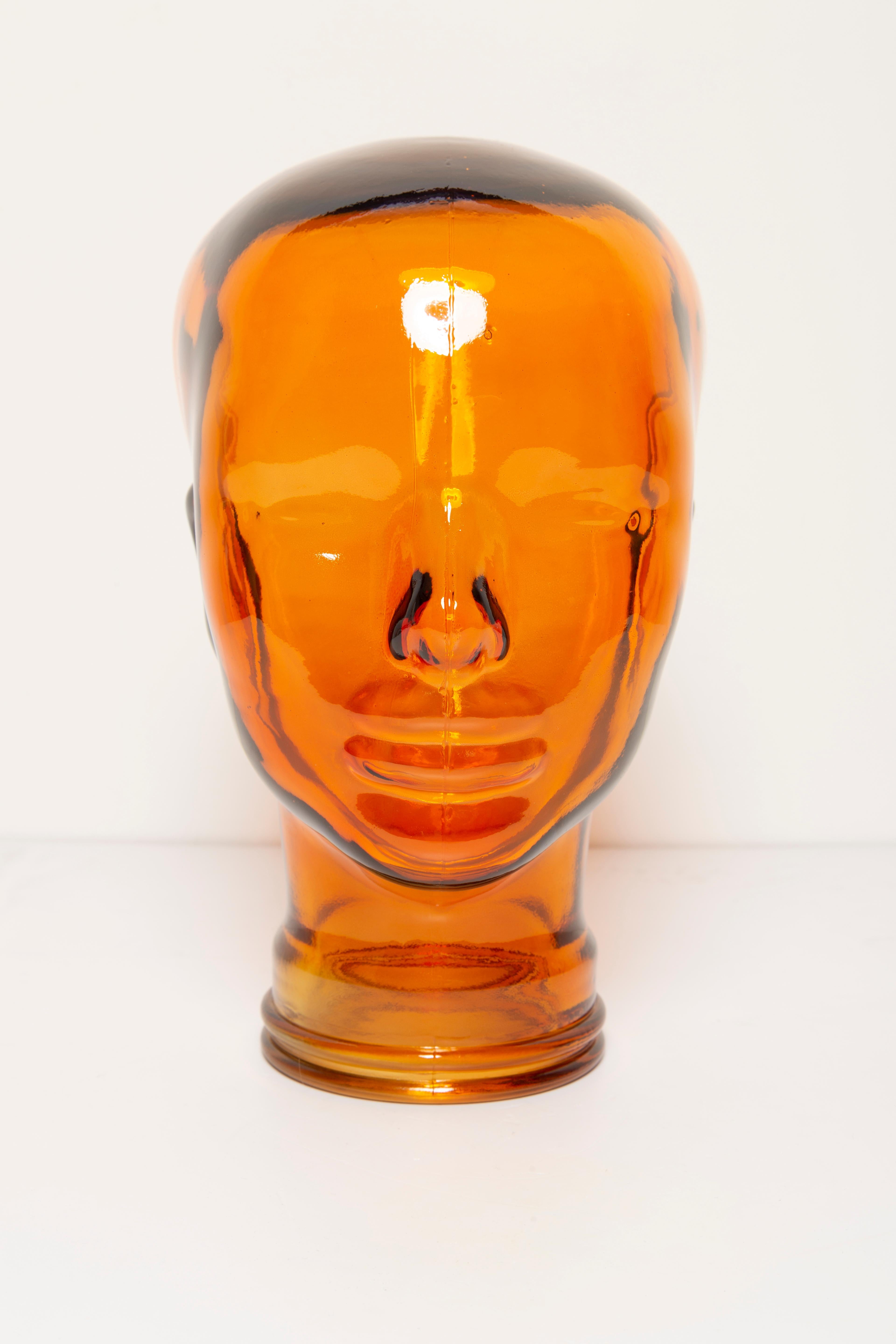 Life-size glass head in a unique orange color. Produced in a German steelworks in the 1970s. Perfect condition. A perfect addition to the interior, photo prop, display or headphone stand.
