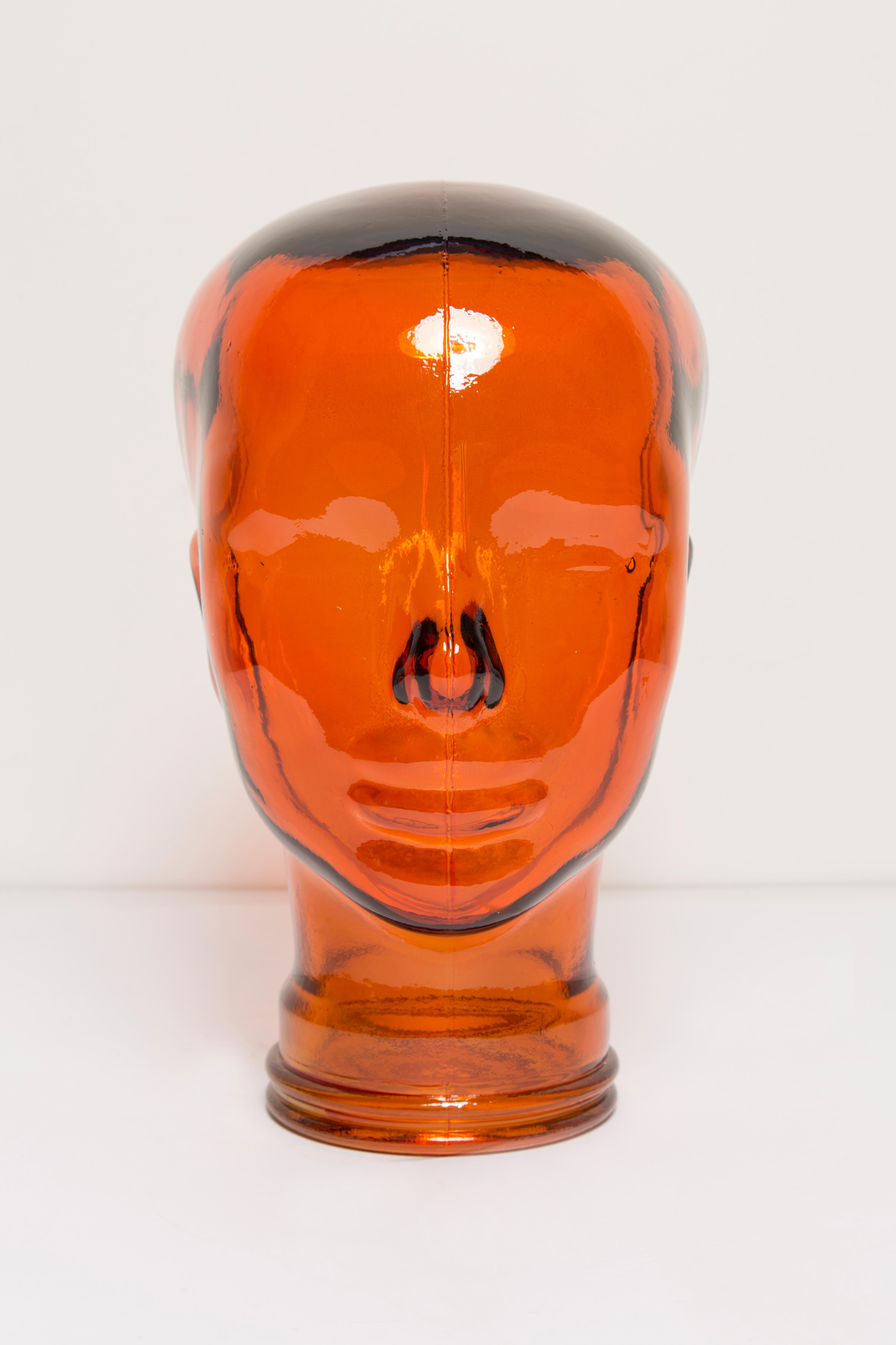 Life-size glass head in a unique orange color. Produced in a German steelworks in the 1970s. Perfect condition. A perfect addition to the interior, photo prop, display or headphone stand.