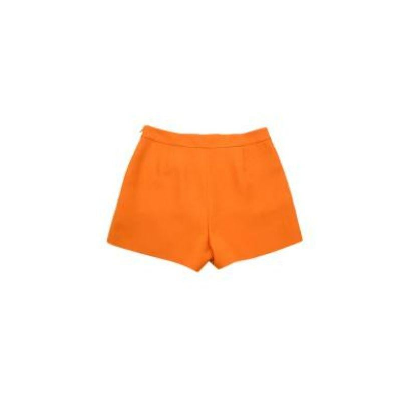 Valentino Orange Wool/ Silk V Logo Shorts
 
 
 
 - Light weight, soft wool/ silk body 
 
 - 3D V belt logo 
 
 - Tailored fit 
 
 - Slip pockets 
 
 - Fully lined with orange silk 
 
 - Side concealed zip fastening 
 
 
 
 Materials:
 
 Shell:
 
