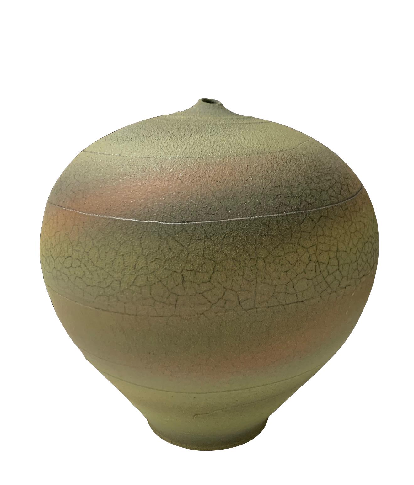 Contemporary textured ceramic earthenware vase.
Green body with bands of pale orange, yellow and blue.
The glaze has a crackle effect giving it an ancient feel.
Tiny top spout.
Hand made one of a kind.
Part of a collection of earthenware vases.