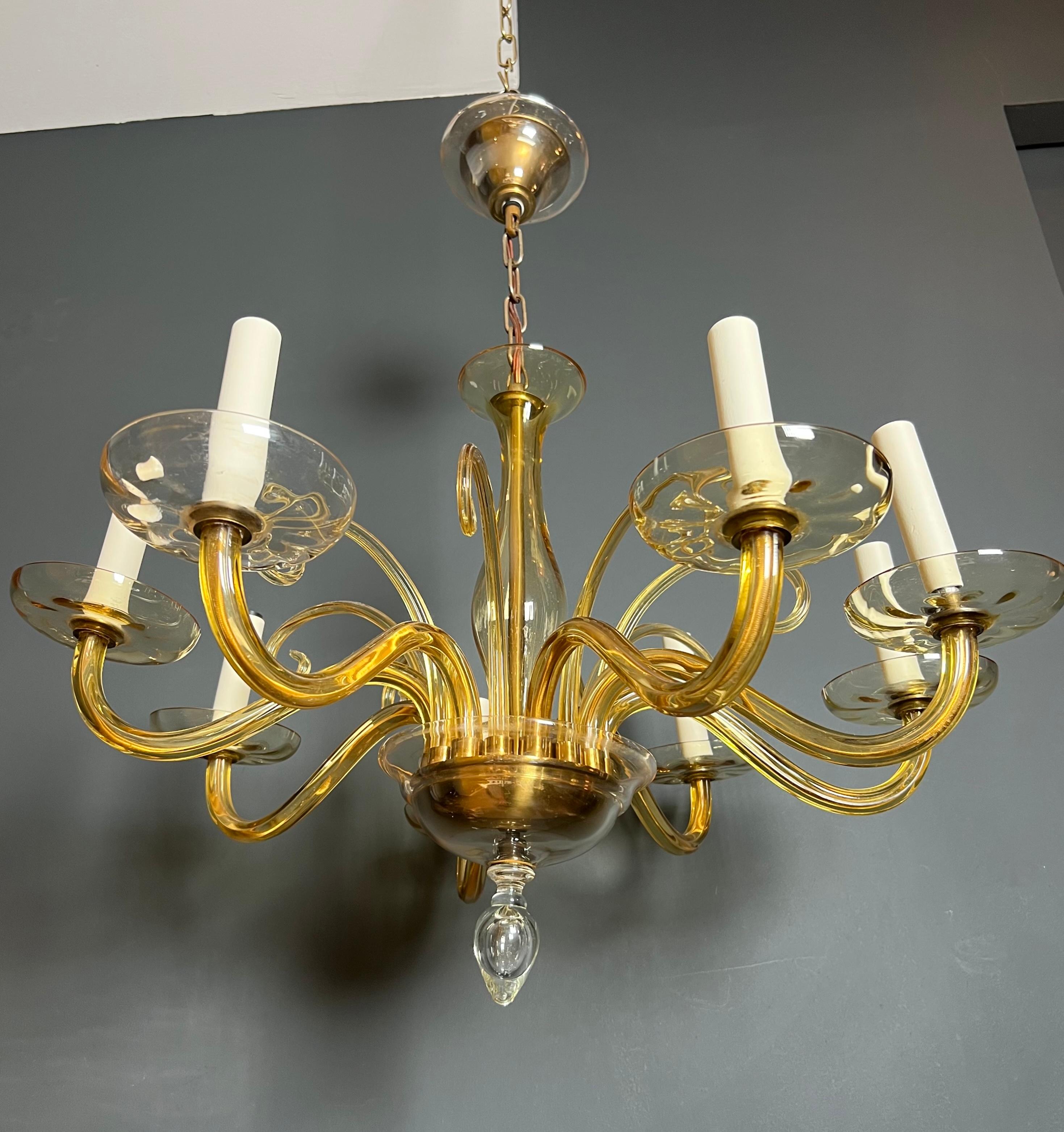 This very nice 8 arms Murano chandelier is made of orangeish crystal. This is an Italian work. Circa 1970
