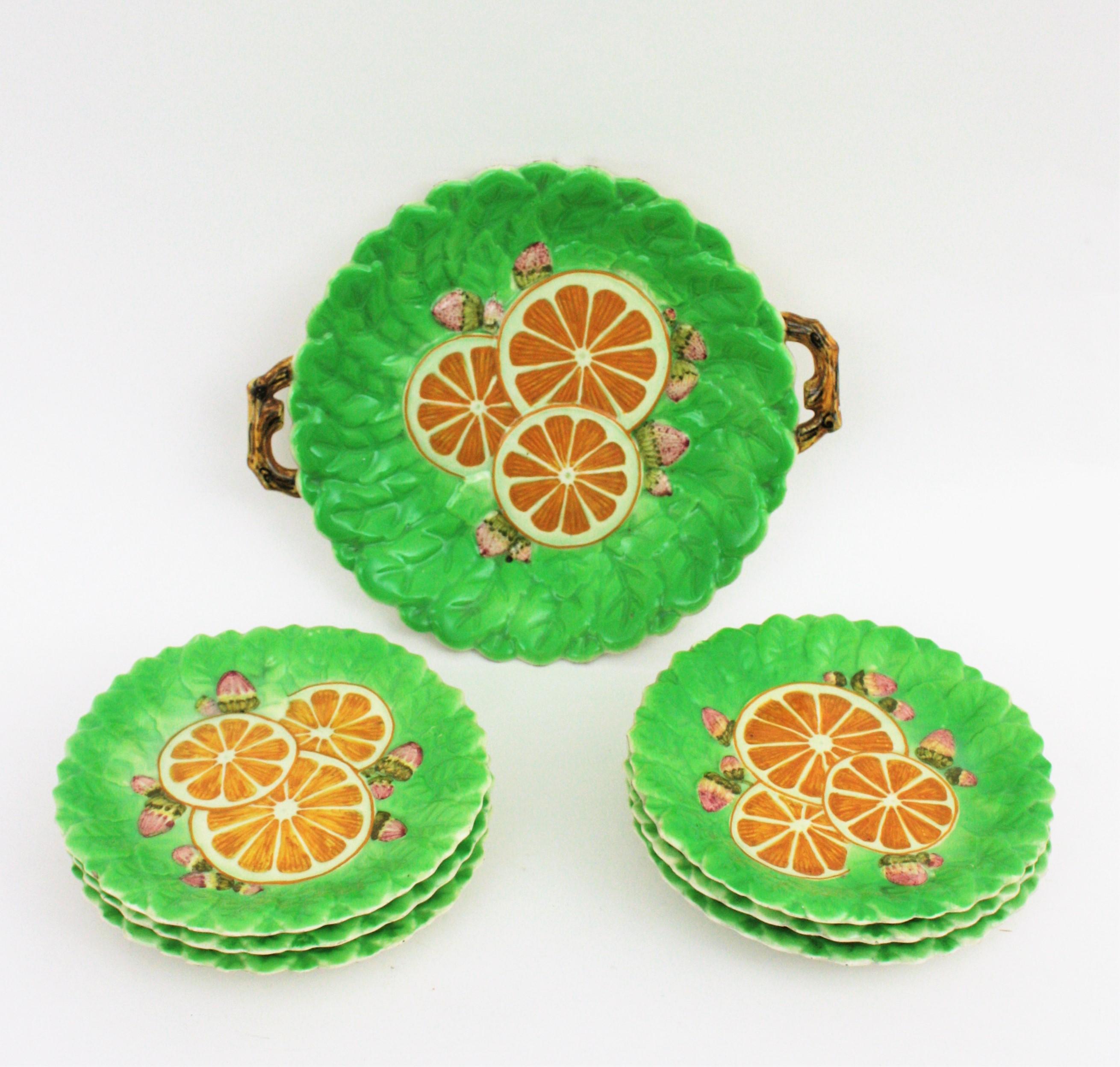 A beautiful glazed ceramic hand painted serving set, France, 1930s-1940s
Set includes 6 dishes and a large serving tray with handles at both sides.
All hand painted with oranges and strawberries scene on a green background. 
For breakfast or dessert