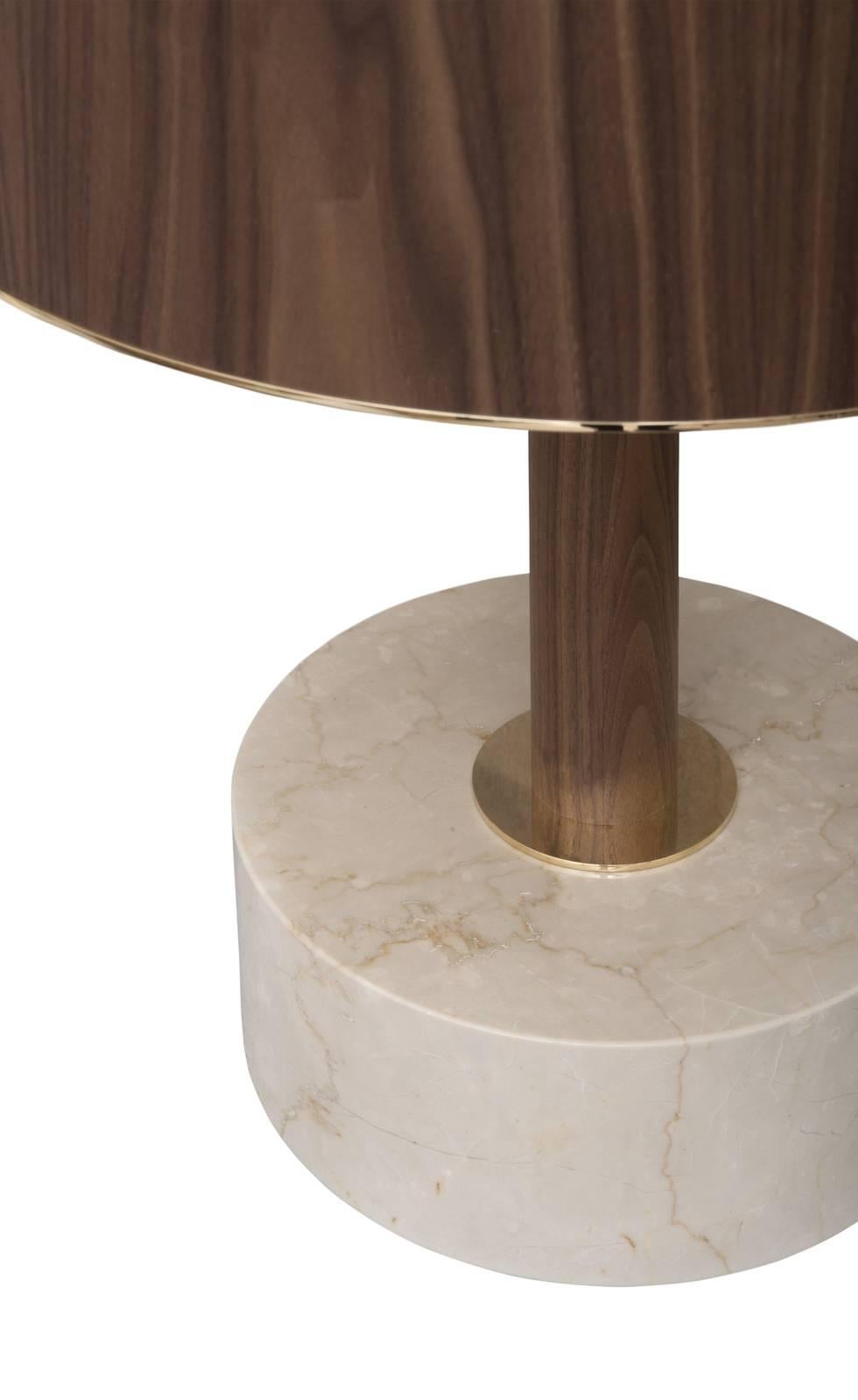 This is a classic table lamp that will enrich any interior with its unexpected, precious details. The white Botticino marble base has a simple round shape that coordinates harmoniously with the drum shape of the Canaletto walnut lampshade, adding