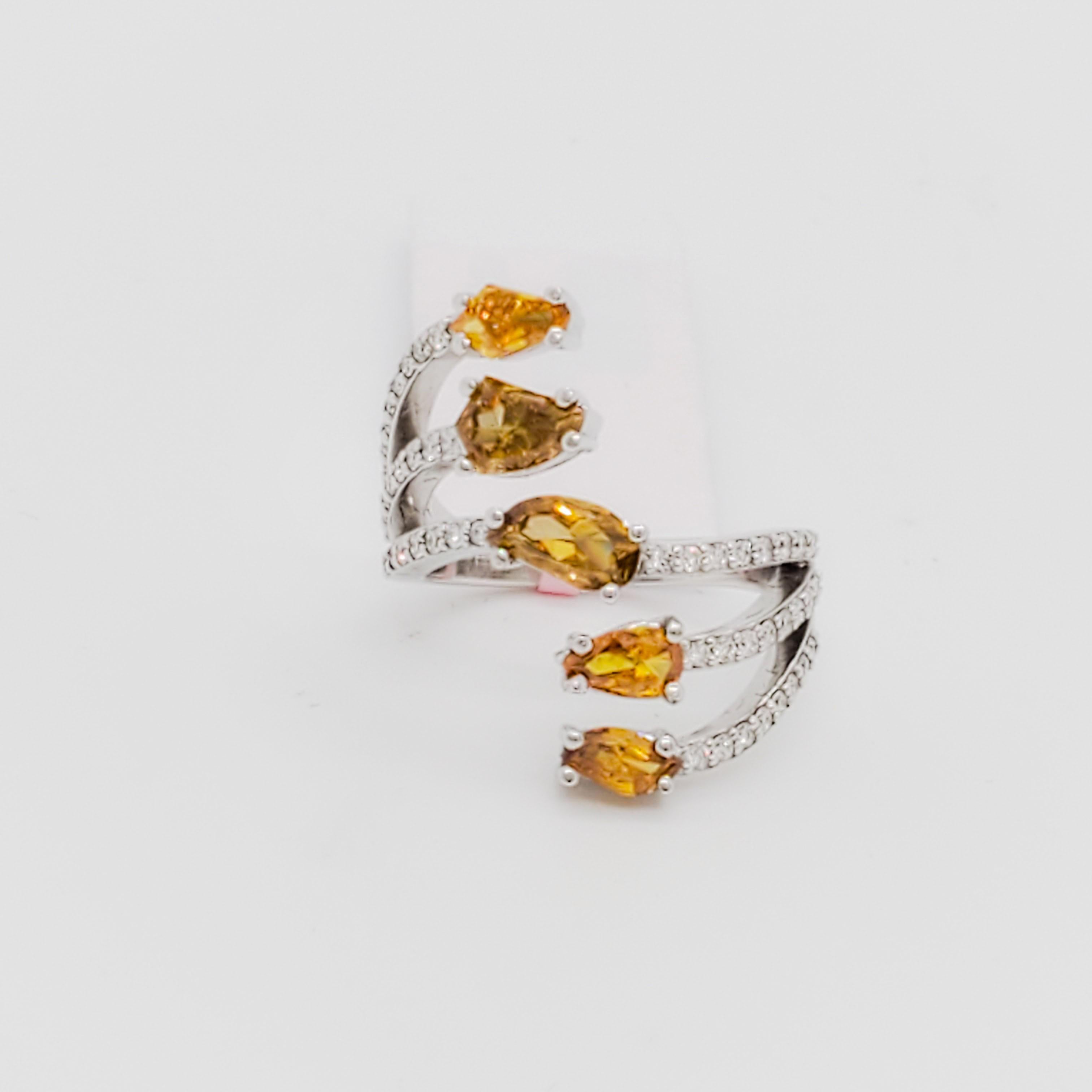 Beautiful 1.48 ct. orangey yellow multi shape diamonds with 0.39 ct. good quality white diamond rounds.  Handmade in 18k white gold.  Ring size 6.5.