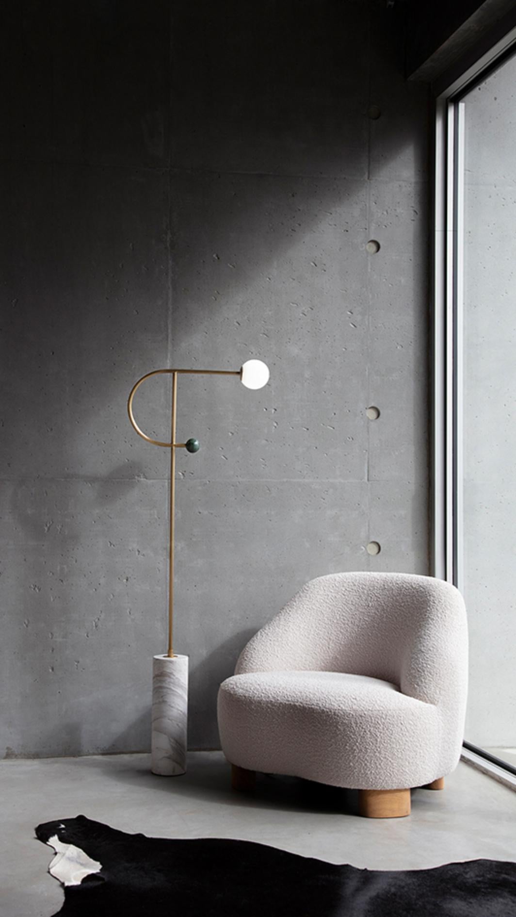 Orb 2 Floor Lamp by Square in Circle
Dimensions: H 165 x W 58 cm
Globe diameter 15 cm
Materials: brushed brass finish, white marble, green marble, opaque white globe

A statement floor lamp with a thin metal frame, a glass globe on one end and a