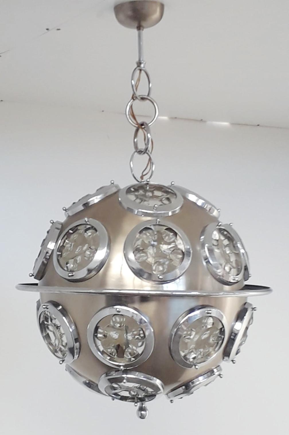 Vintage Italian chandelier with brushed steel circular structure and optical beveled glass lenses / Designed by Oscar Torlasco for Lumi circa 1960s / Made in Italy
6 lights / E12 or E14 type / max 40W each
Measures: Diameter: 19.5 inches / total