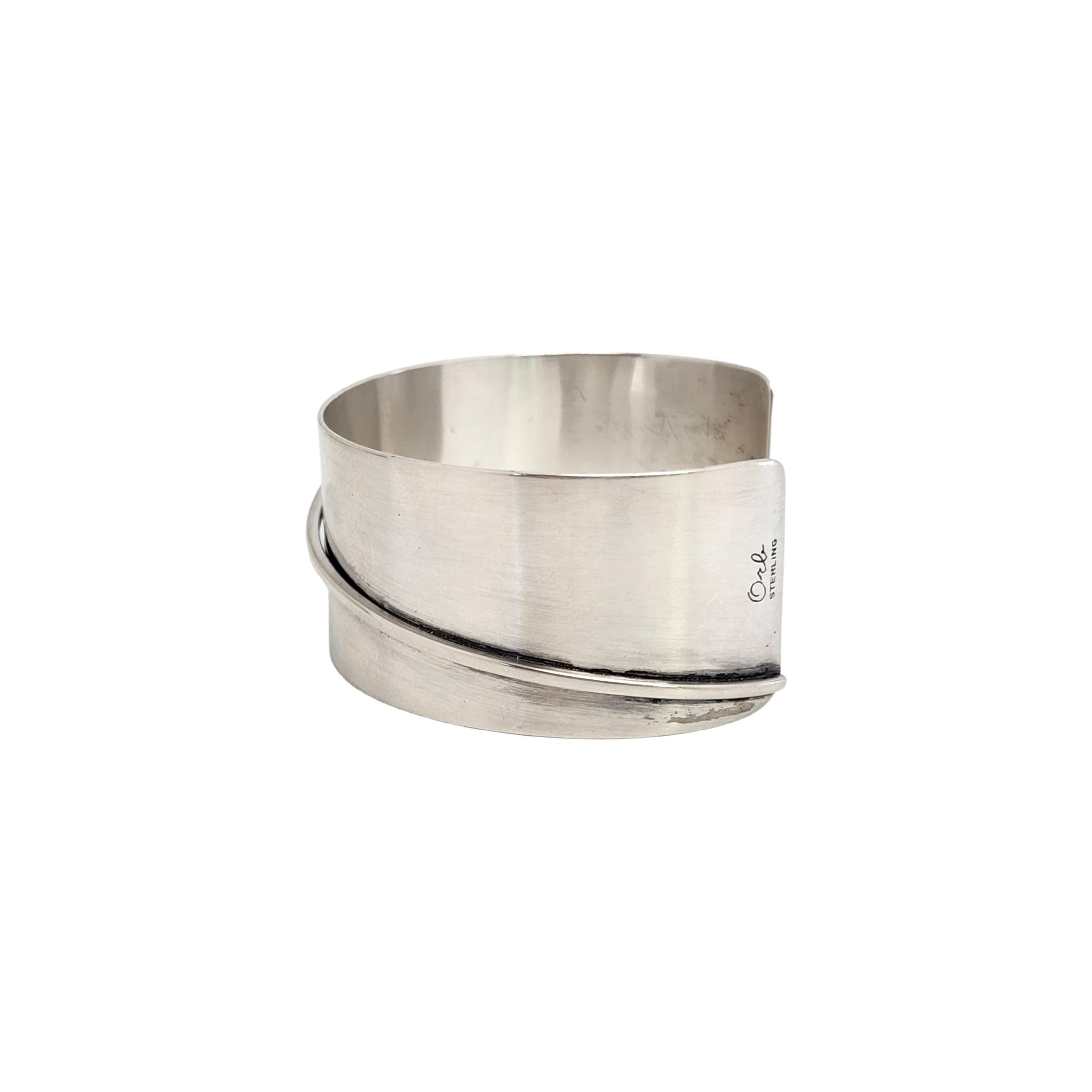 Sterling silver modern design cuff bracelet by Orb, Otto Robert Bade.

Beautiful modernist design cuff bracelet featuring an applied corner to corner thick wire.

Measures approx 5 3/4