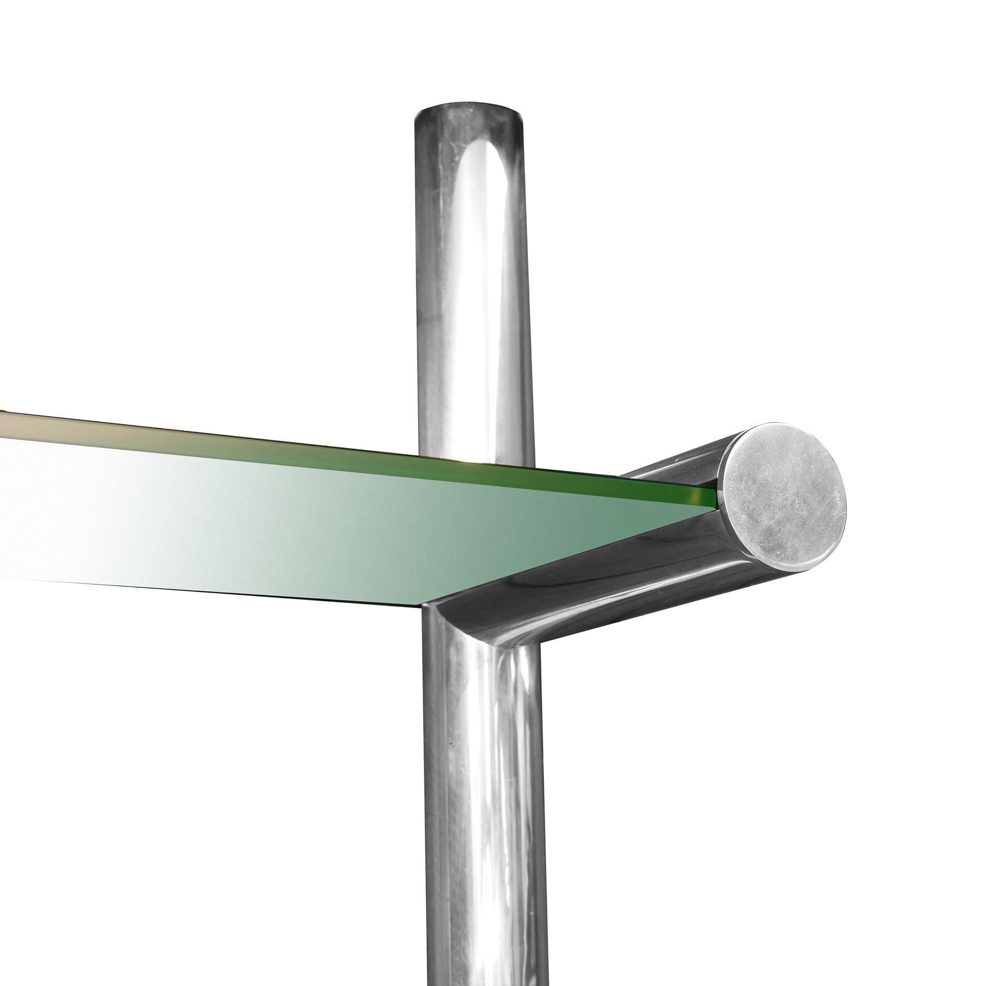 Impressive wall system of extruded polished aluminum incorporating lighting and shelves. Schwietzer's patented design incorporates sophisticated engineering to achieve the appearance of invisible joinery at each cantilevered shelf. This unit is