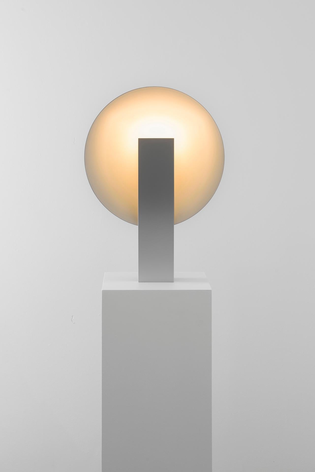 ORBE is a table lamp with indirect light, designed to provide soft illumination to the environment.

The piece has a simple structure, composed by the minimum required for its functionality: the front box houses the light source and provides the