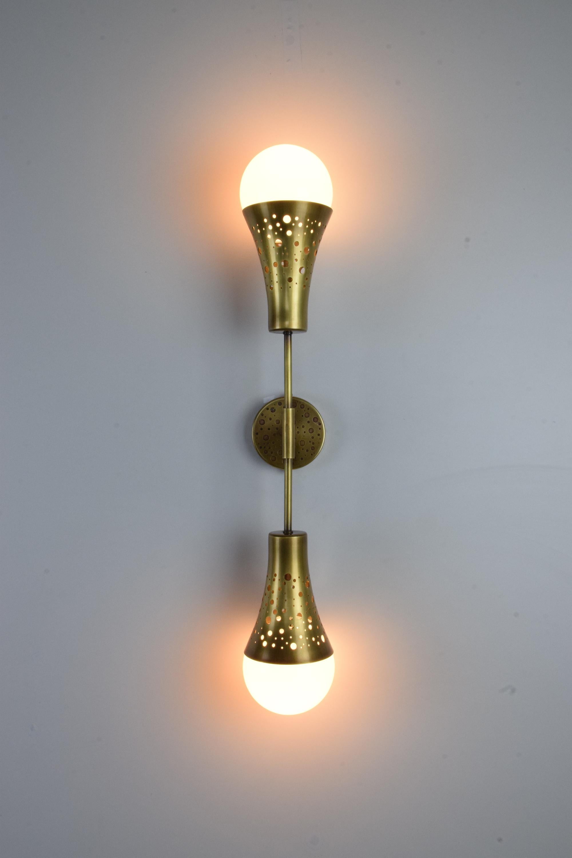 This wall light by Jonathan Amar Studio is a reference to the earth's circular shape; the ORBI-w2M2 is a symmetrical double shade in perforated brass that diffuses a soft light upwards and downwards with glass globes. 

Light Source 
2x60 W Max
