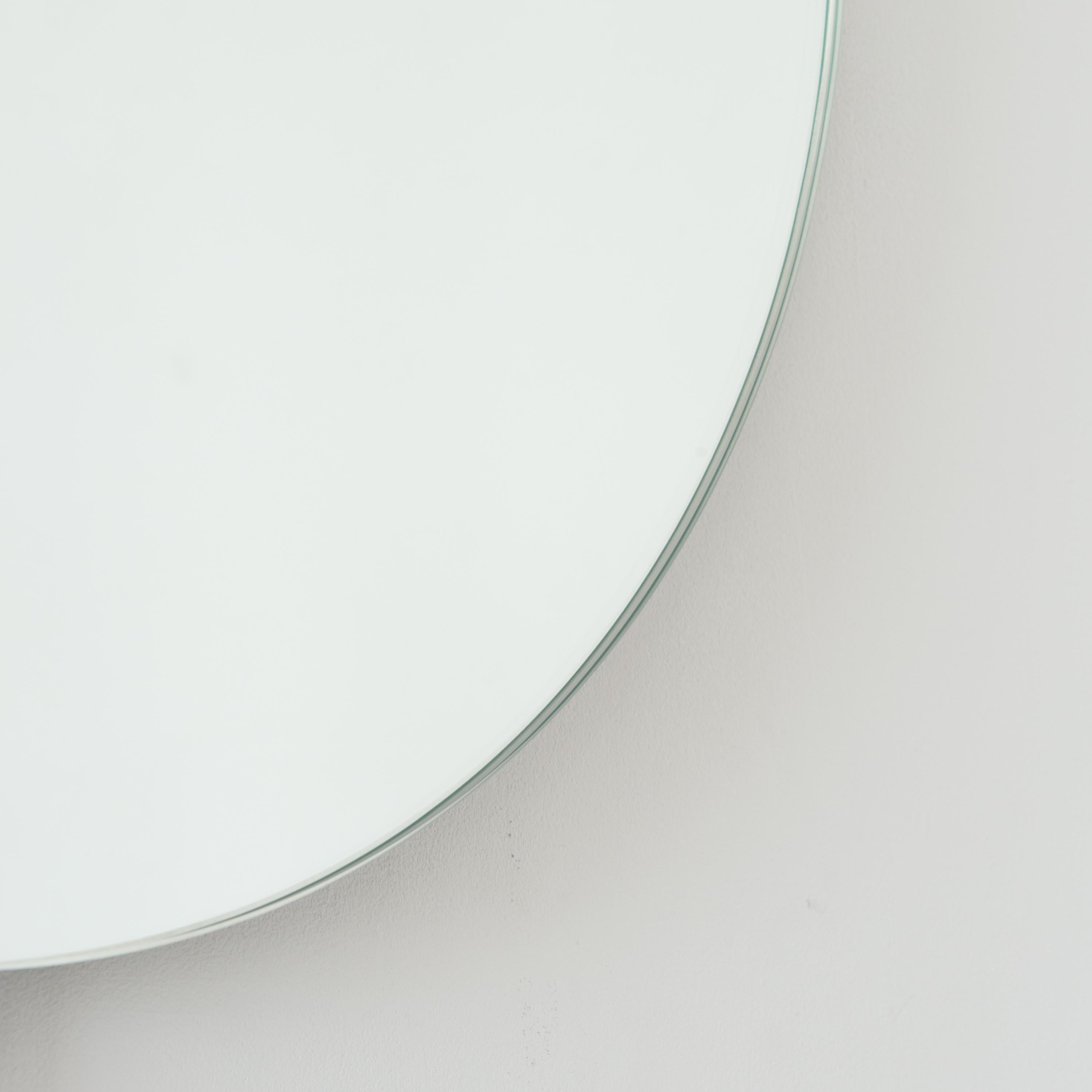 Contemporary back illuminated round frameless mirror with a floating effect. Quality design that ensures the mirror sits perfectly parallel to the wall. Designed and made in London, UK.

Fitted with professional plates not visible once installed for