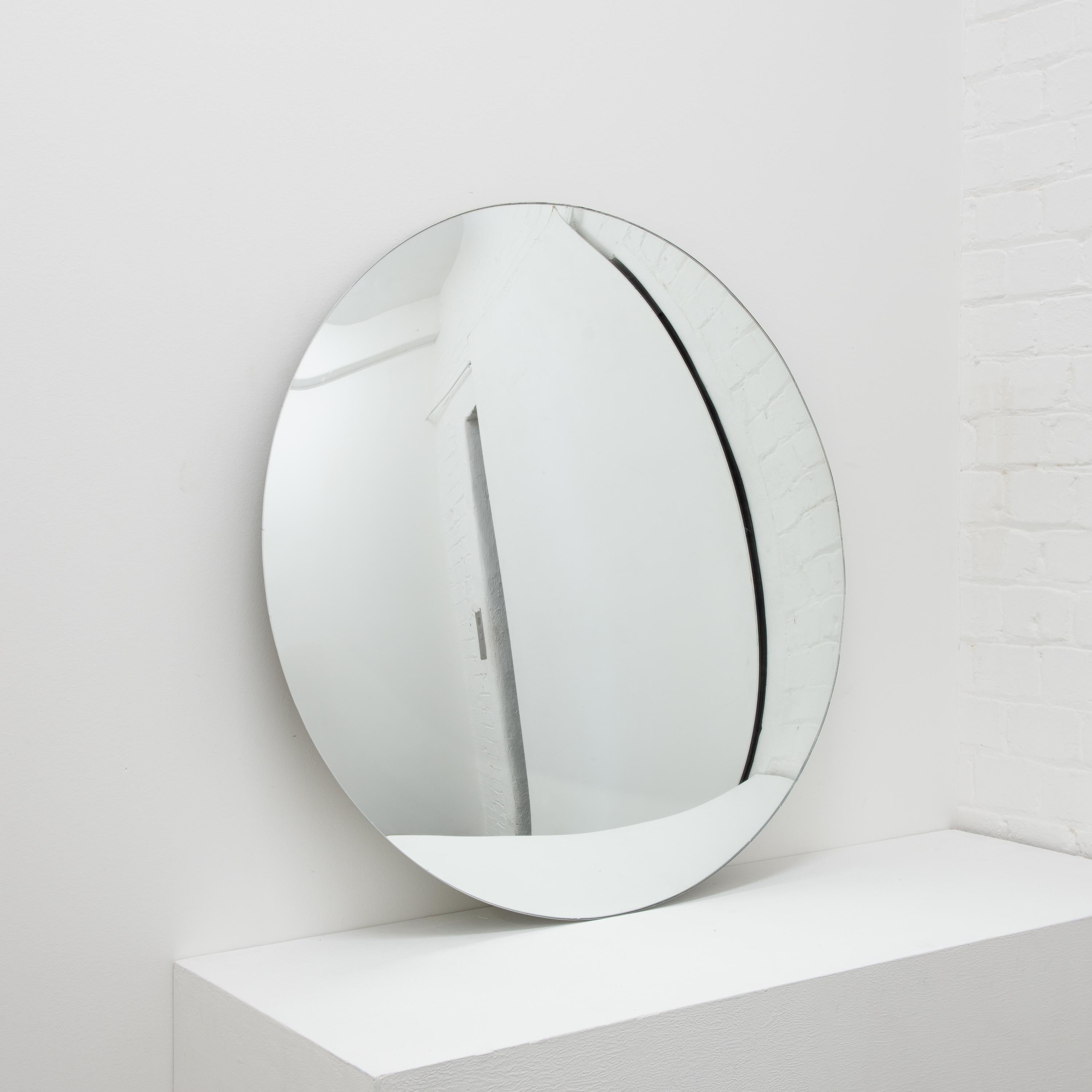Minimalist frameless convex mirror.

Each Orbis™ convex mirror is designed and handcrafted in London, UK. Slight variations in sizes and imperfections on edges and surface finishes are characteristics of such original handmade creations. These