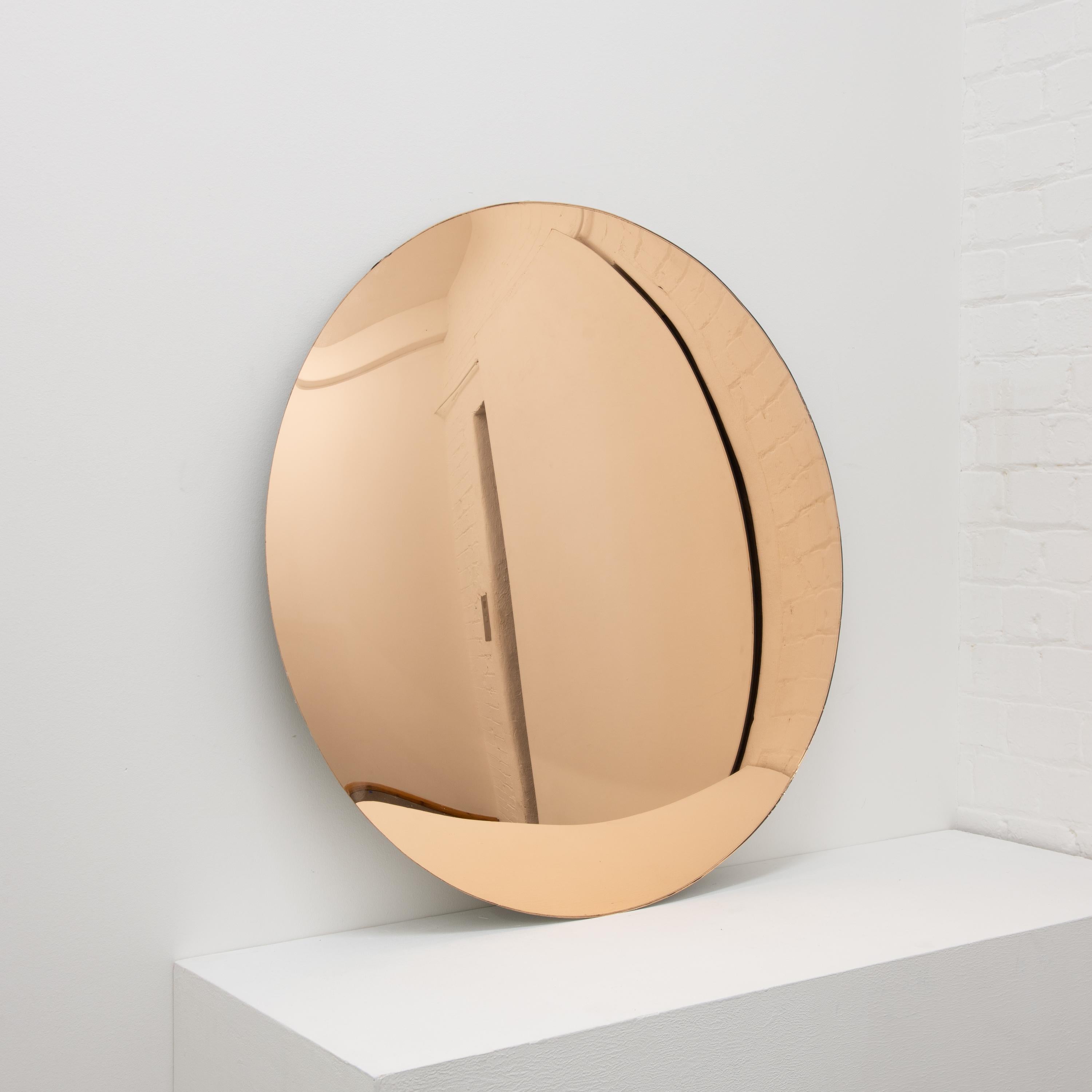 Beautiful rose gold tinted convex frameless mirror with brass clips.

Each Orbis™ convex mirror is designed and handcrafted in London, UK. Slight variations in sizes and imperfections on edges and surface finishes are characteristics of such