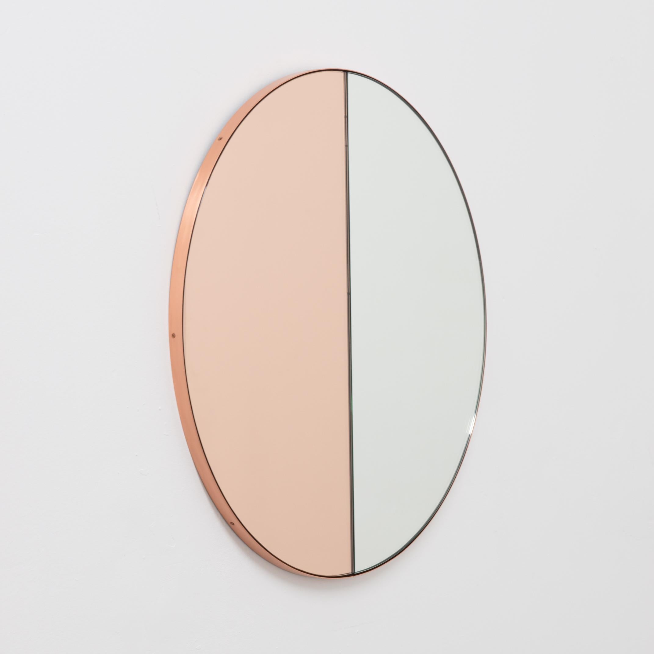 Contemporary mixed tinted (silver & rose gold / peach) Orbis Dualis™ mirror with a chic brushed copper frame. Designed and handcrafted in London, UK.

All mirrors are fitted with an ingenious French cleat (split batten) system so they may hang flush