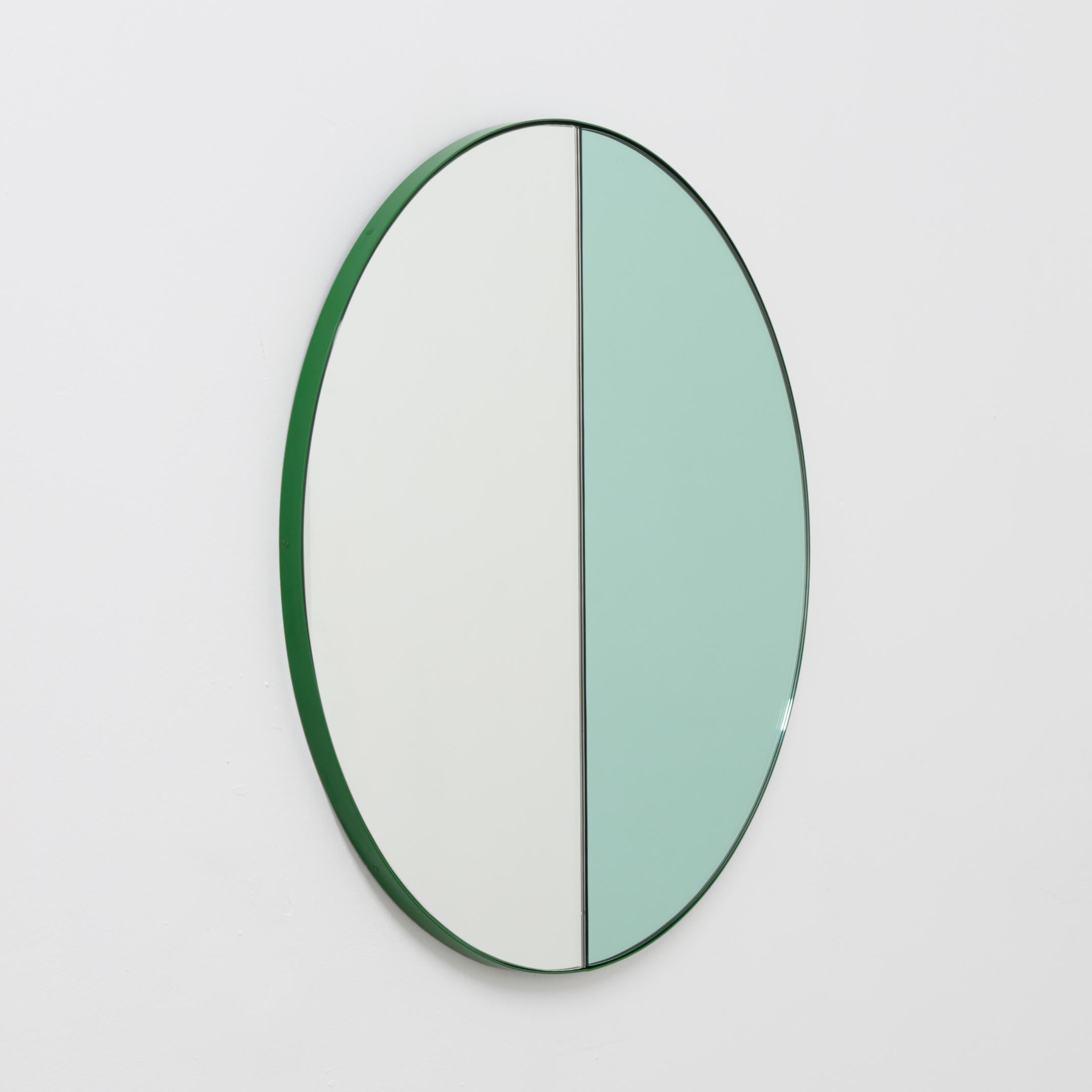 Delightful handcrafted mixed tinted (silver & green) Orbis Dualis mirror with a modern green frame.

Designed and handcrafted in London, UK. The detailing and finish, including visible screws, emphasise the craft and quality feel of the mirror, a