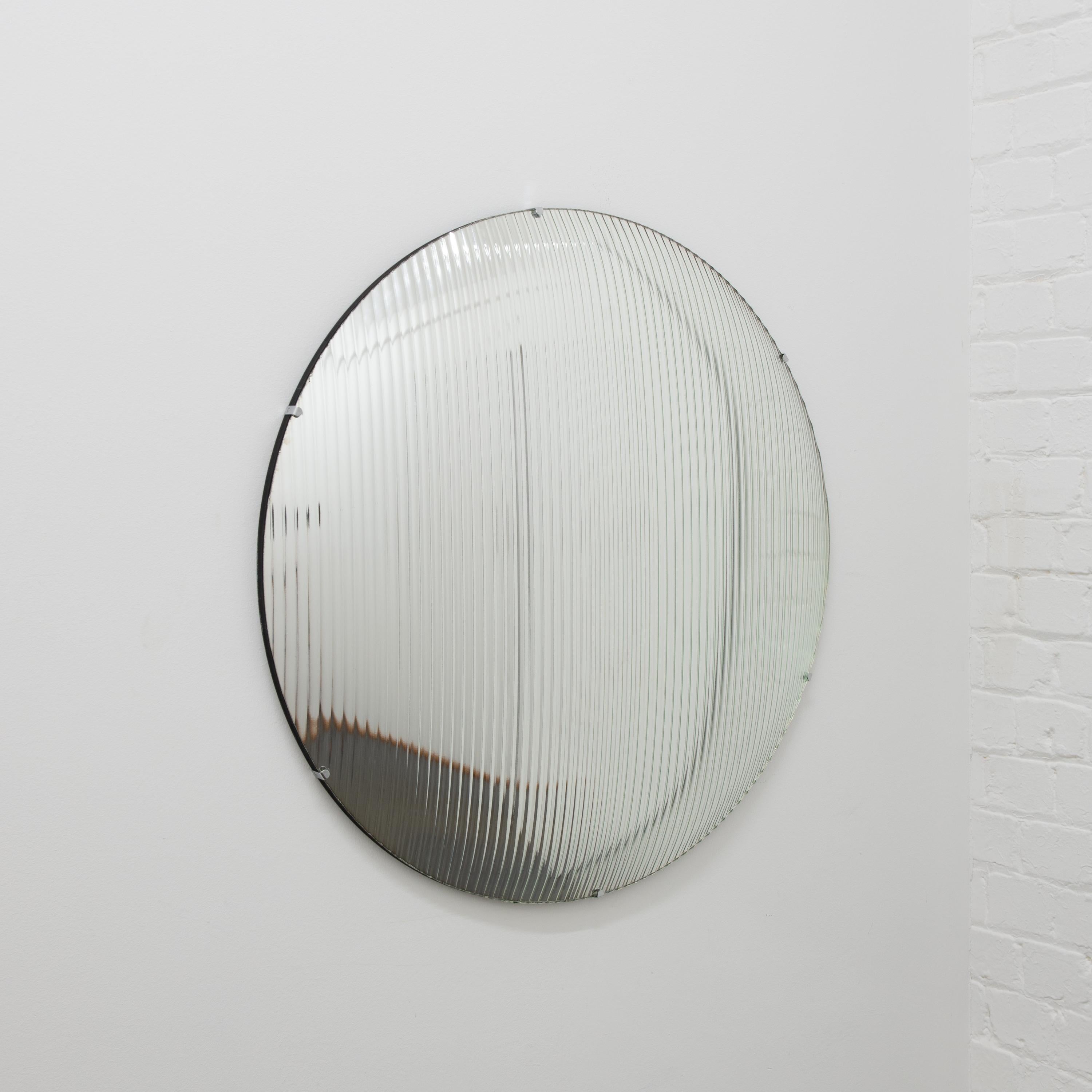 Stunning decorative reeded glass round convex frameless mirror with stainless steel clips.

Each Orbis™ convex mirror is designed and handcrafted in London, UK. Slight variations in sizes and imperfections on edges and surface finishes are