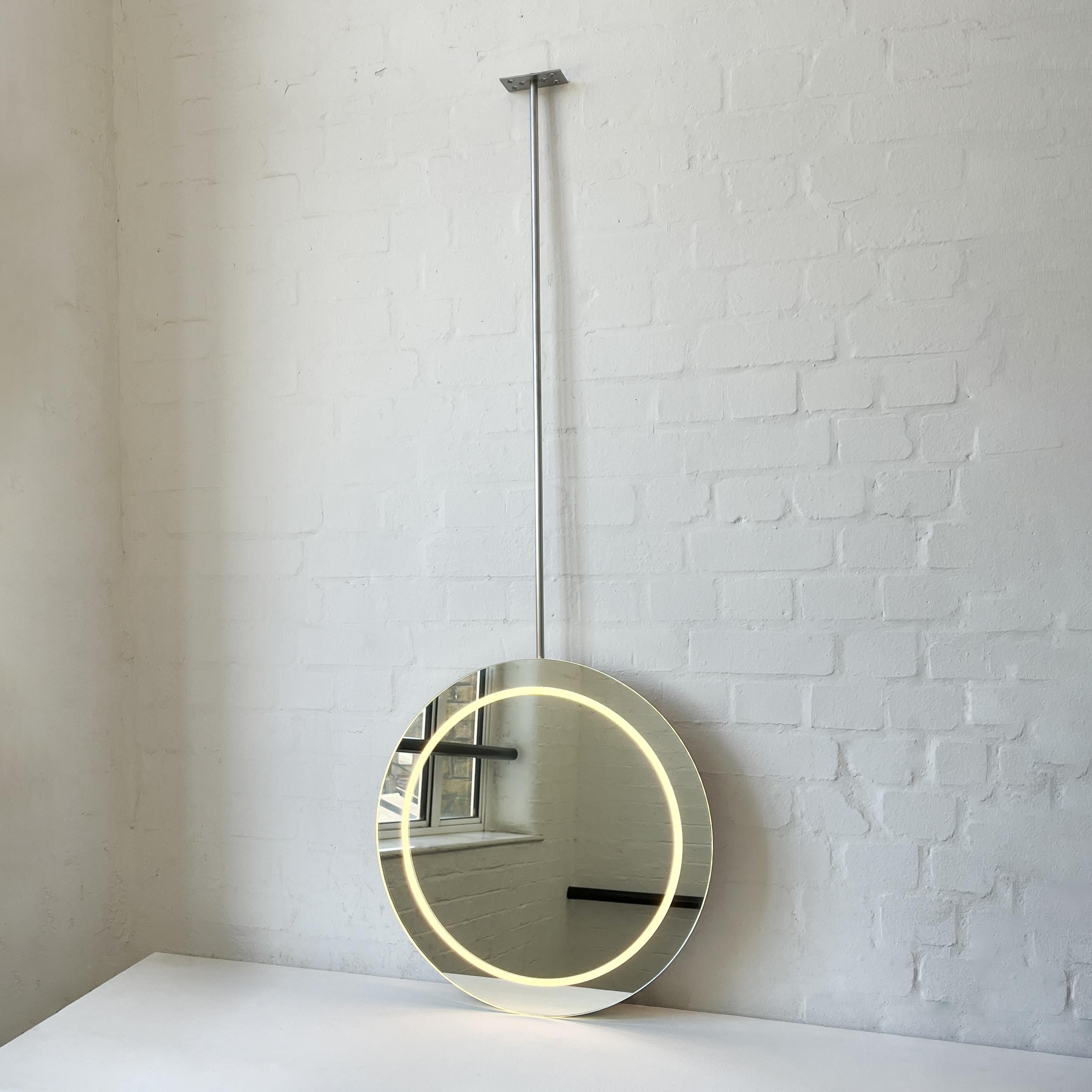 Contemporary illuminated ceiling suspended Orbis™ round frameless mirror. Designed and handcrafted in London, UK. This mirror is fully customisable to suit the specific requirements of each interior.

Cover plates. The ceiling plates are supplied