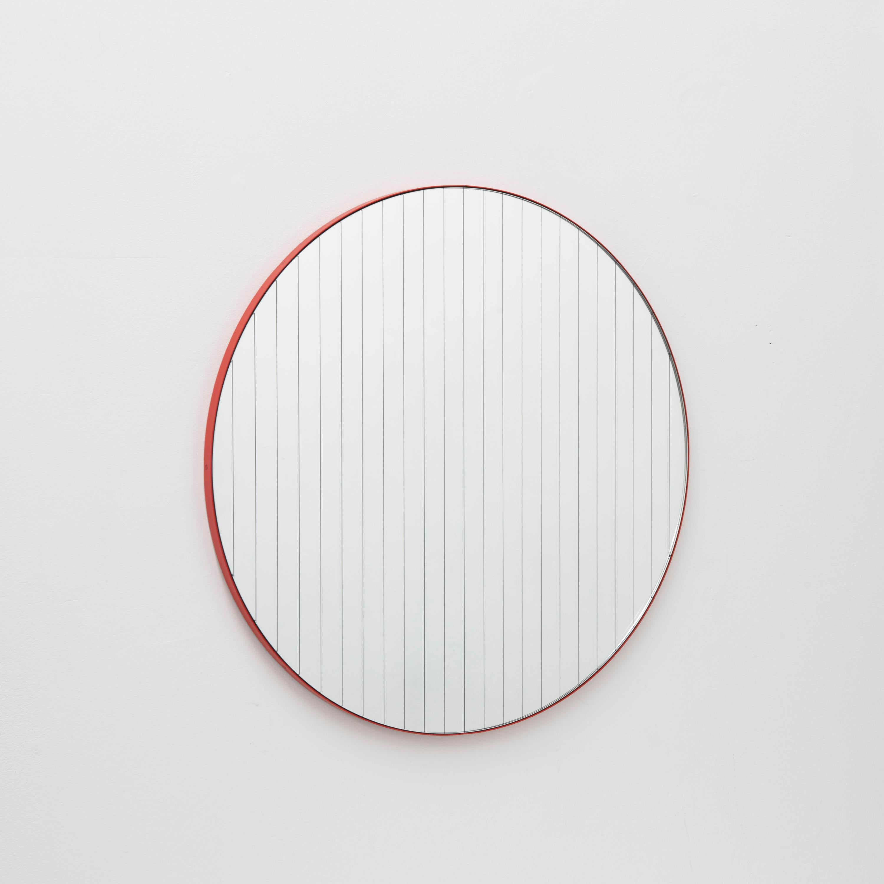 New Orbis Linus™ round mirror with elegant etched strips and a modern red frame. Designed and handcrafted in London, UK.

Fitted with a brass hook or an aluminium z-bar (depending on the size of the mirror), that allow for the hanging of the