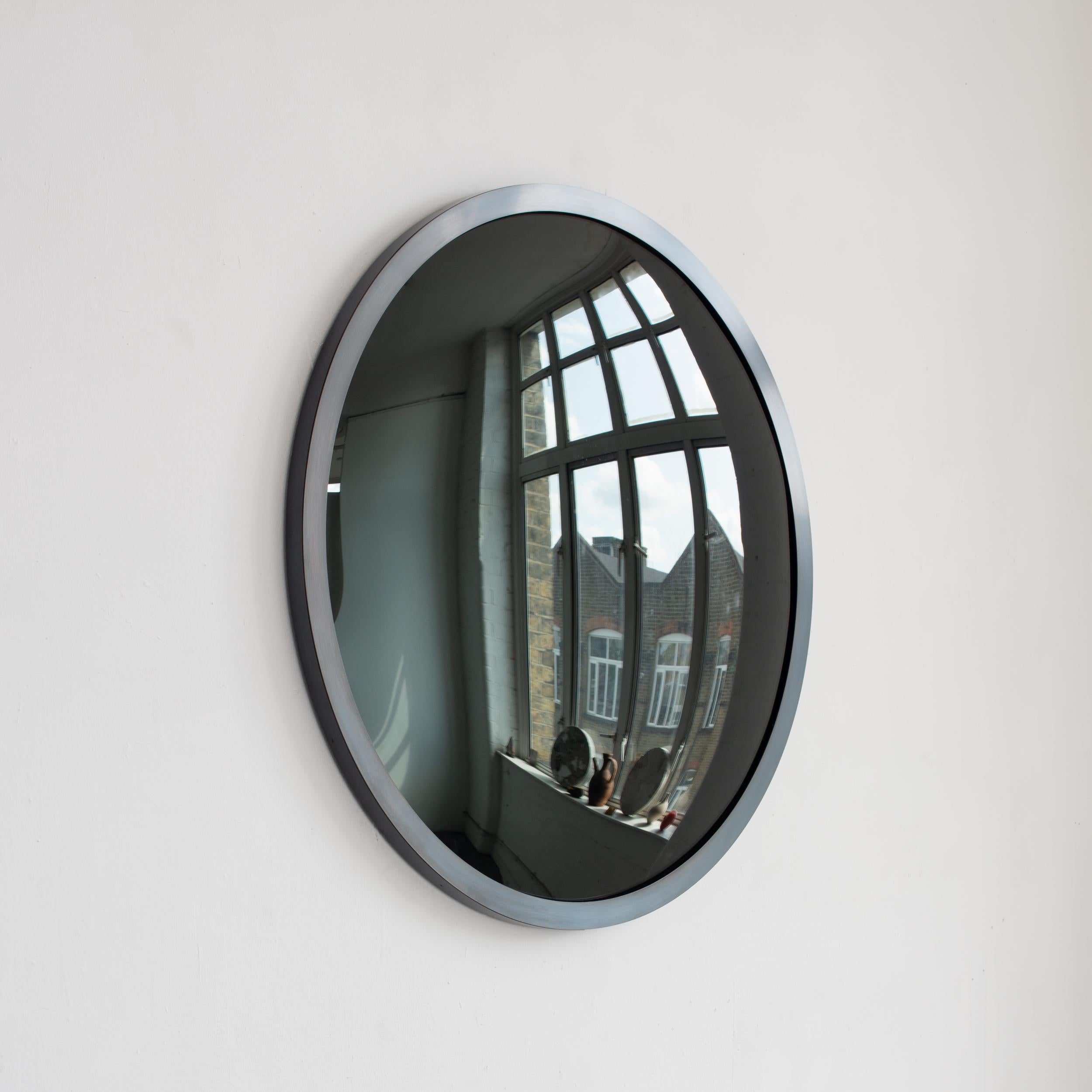 Stunning convex black tinted mirror with a blackened metal frame.

Each Orbis™ convex mirror is designed and handcrafted in London, UK. Slight variations in sizes and imperfections on edges and surface finishes are characteristics of such original