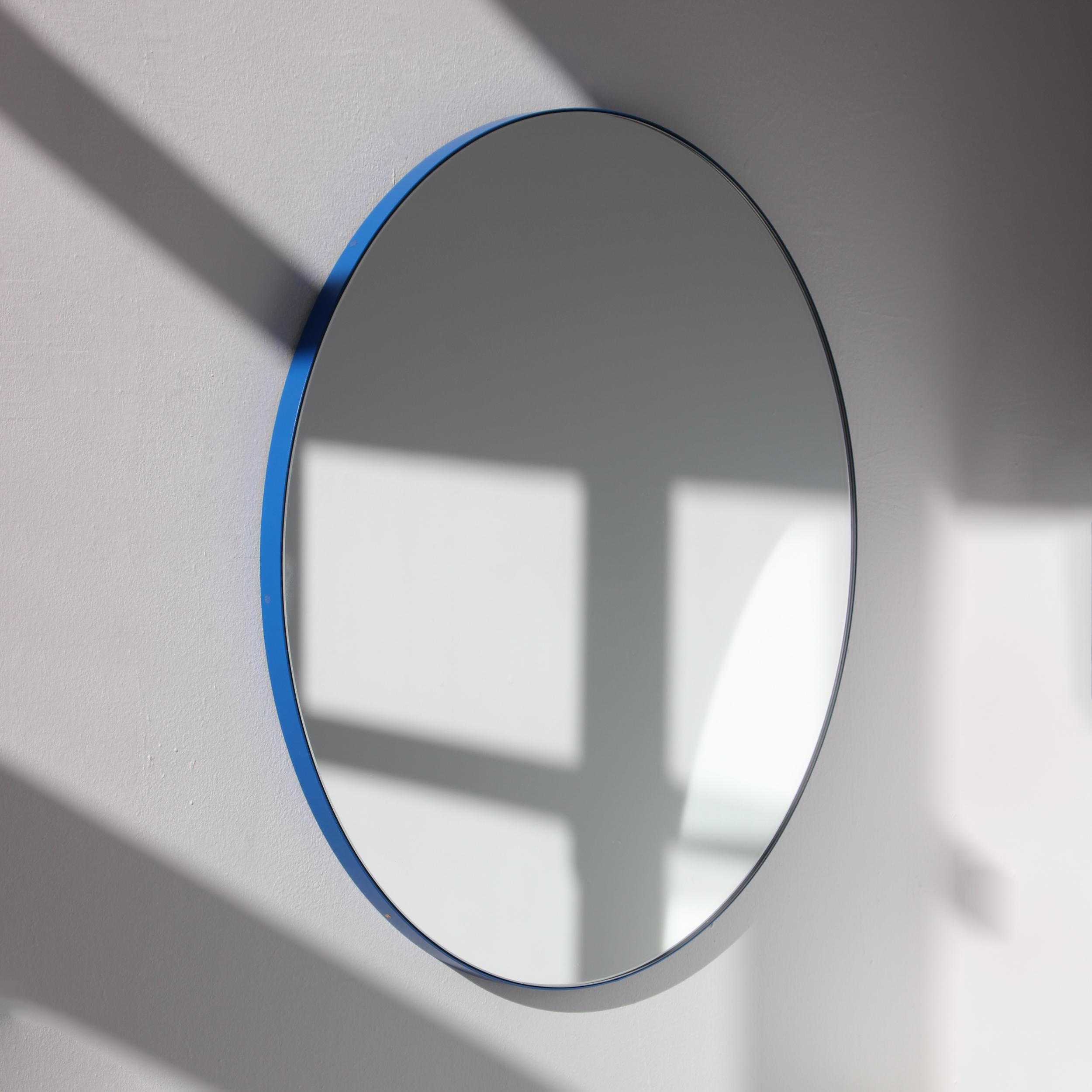 Minimalist round mirror with a modern aluminium powder coated blue frame. Designed and handcrafted in London, UK.

Medium, large and extra-large mirrors (60, 80 and 100cm) are fitted with an ingenious French cleat (split batten) system so they may
