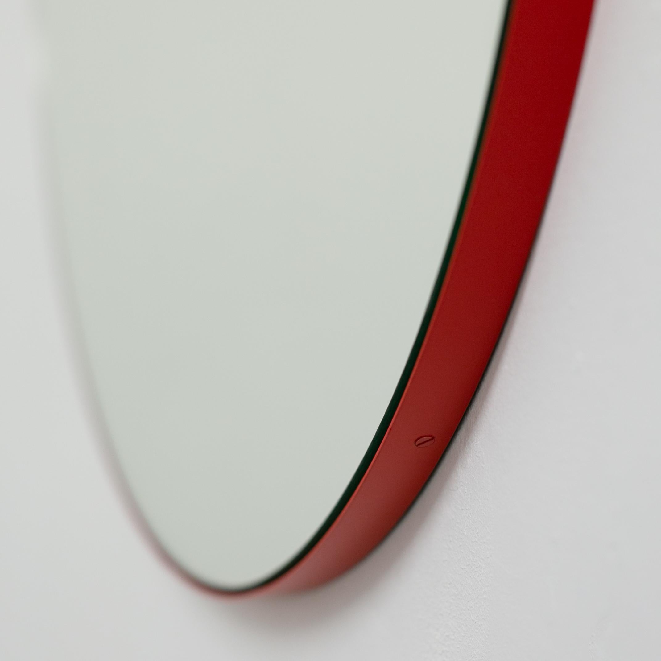 Minimalist round mirror with a modern aluminium powder coated red frame. Designed and handcrafted in London, UK.

Medium, large and extra-large mirrors (60, 80 and 100cm) are fitted with an ingenious French cleat (split batten) system so they may