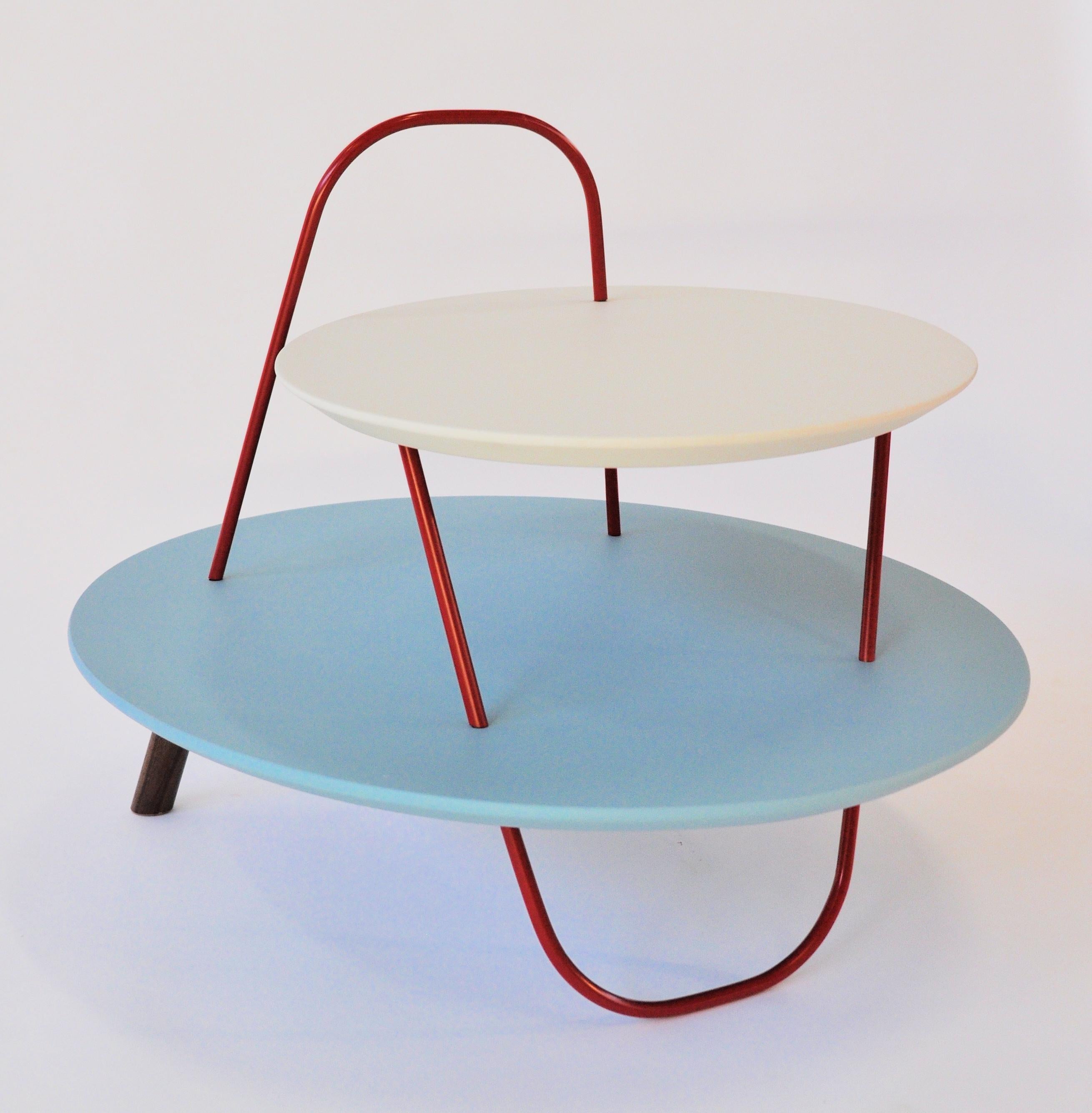 As free trajectories in space, metal structures create winding geometries. Orbit is a family of tables with a unique image. Curved tubulars cross - on several levels – with circular or elliptical wooden tops. Orbit can be a contemporary table, a