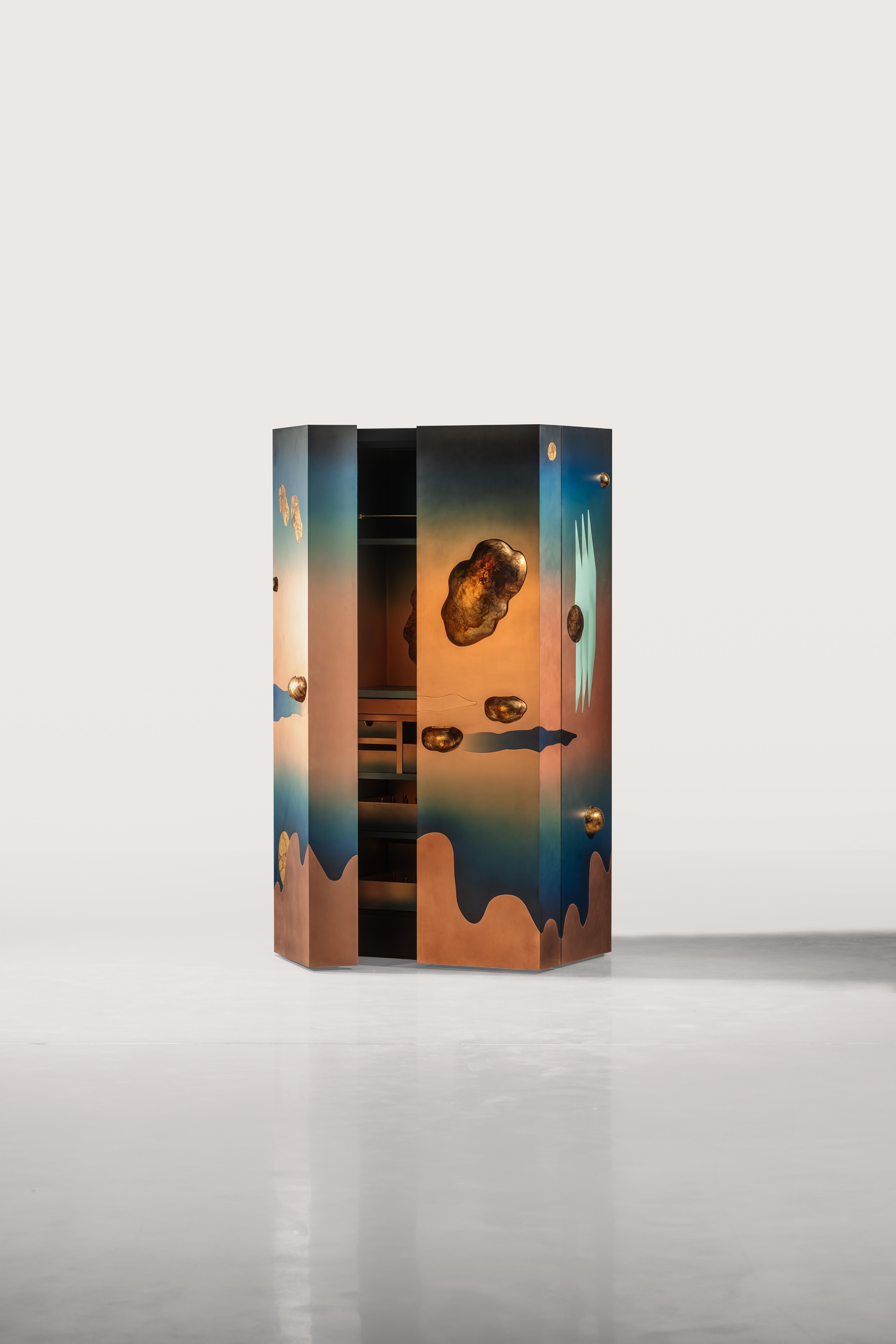 The Orbit Bar is a mastery in abstract design with floating planets against coppery blue skies and intricate interiors to hold a full bar. Transform your home with this elegant and timeless cabinet with drawers and shelves to house your