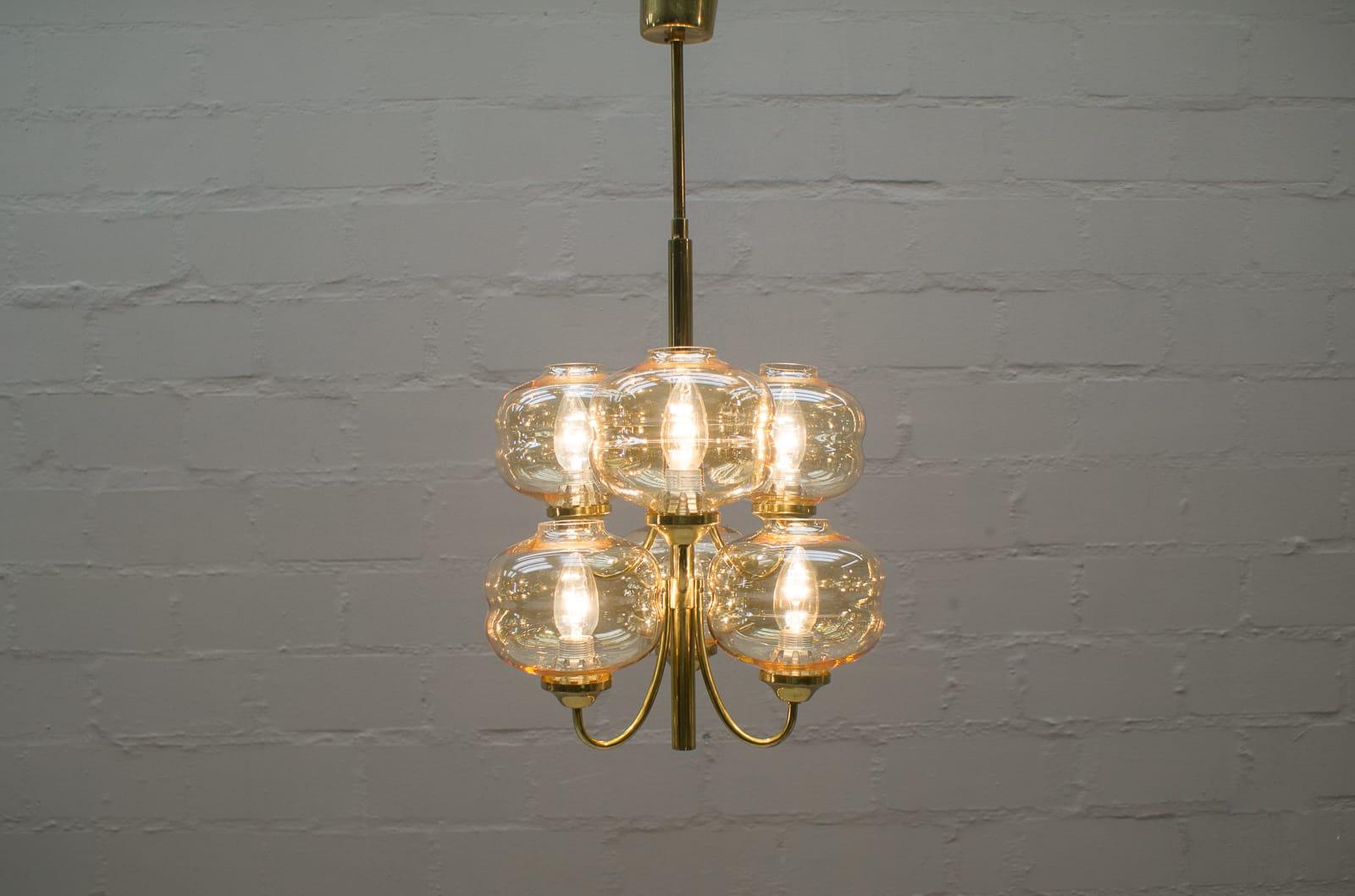 Elegant Mid-Century Modern chandelier. 

Executed in massive brass. The chandelier needs 6 x E14 Edison screw fit bulb.

They are wired, in working condition and run both on 110 / 230 volt.
