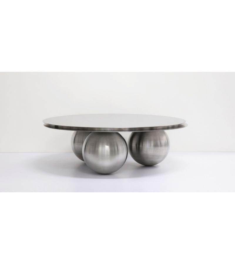 Orbit coffee table by Batten and Kamp
Limited edition of 24 + 3 AP.
Dimensions: Diameter 110 x H 33 cm 
Materials: Hand brushed stainless steel

The top can be made to buyer's preference.

Batten and Kamp is a creative partnership between