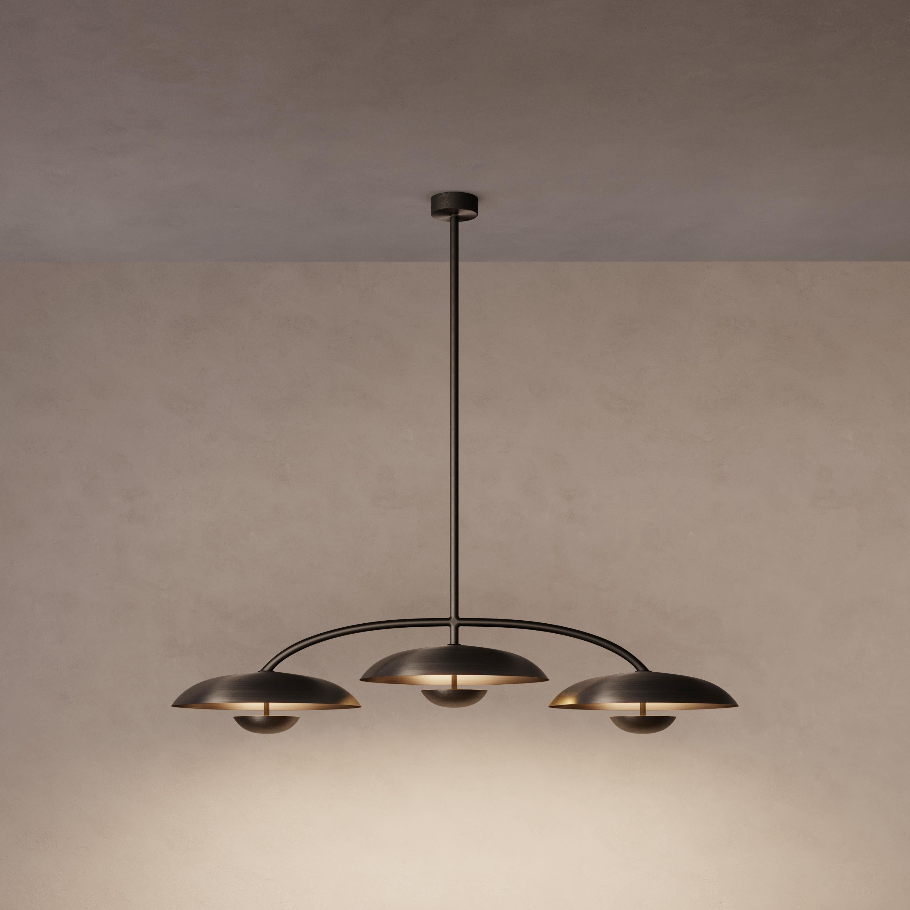 Trio for three, a unique ceiling light composed by a cluster of lighting components. Combining patinated brass plates and finely brushed brass framework, the Orbit Trio ceiling light is softly illuminated with LED elements from within.
 
This