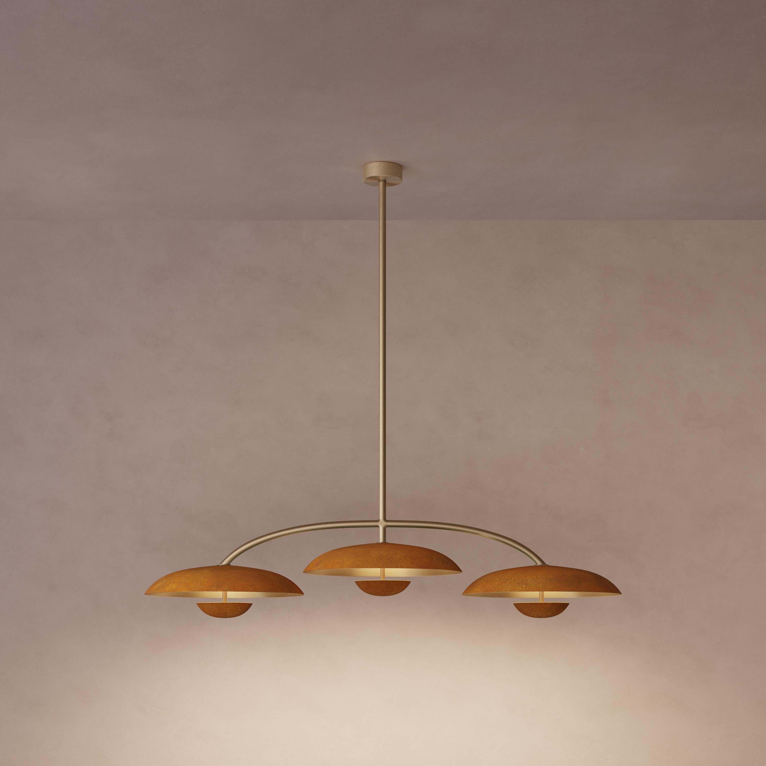 Trio for three, a unique ceiling light composed of a cluster of lighting components. Combining patinated brass plates and finely brushed brass framework, the Orbit Trio ceiling light is softly illuminated with LED elements from within. This