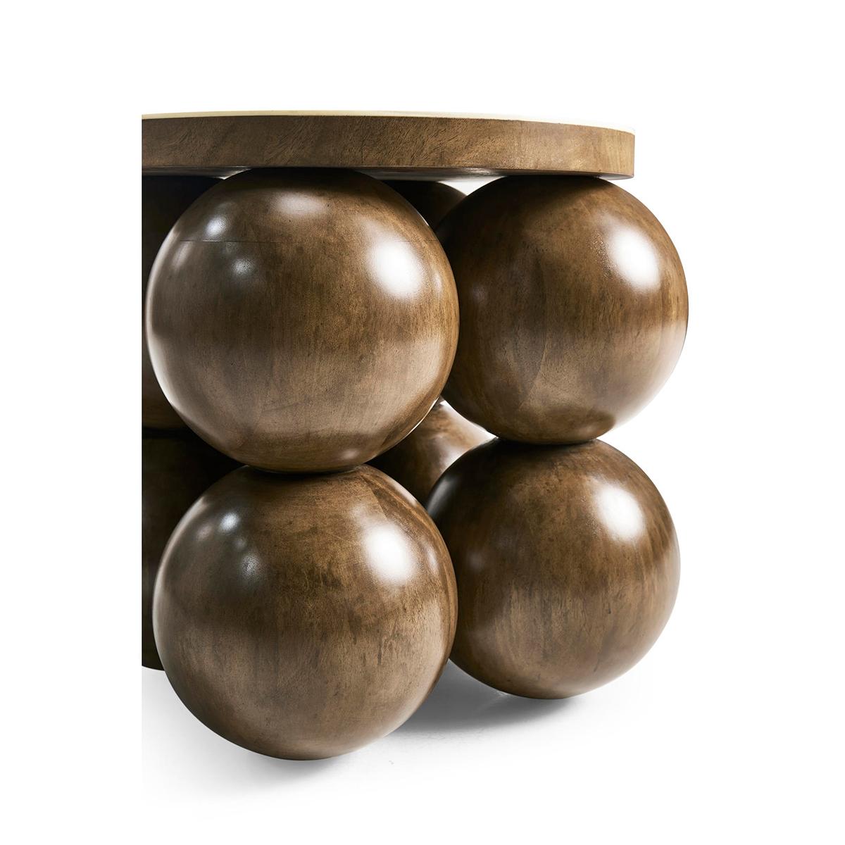 The table's solid wood-stacked orbs form a charismatic foundation that fuses art and functionality. These orbs create a unique and eye-catching design that adds personality to the piece.

The faux bone inlay banding to the round top creates a subtle