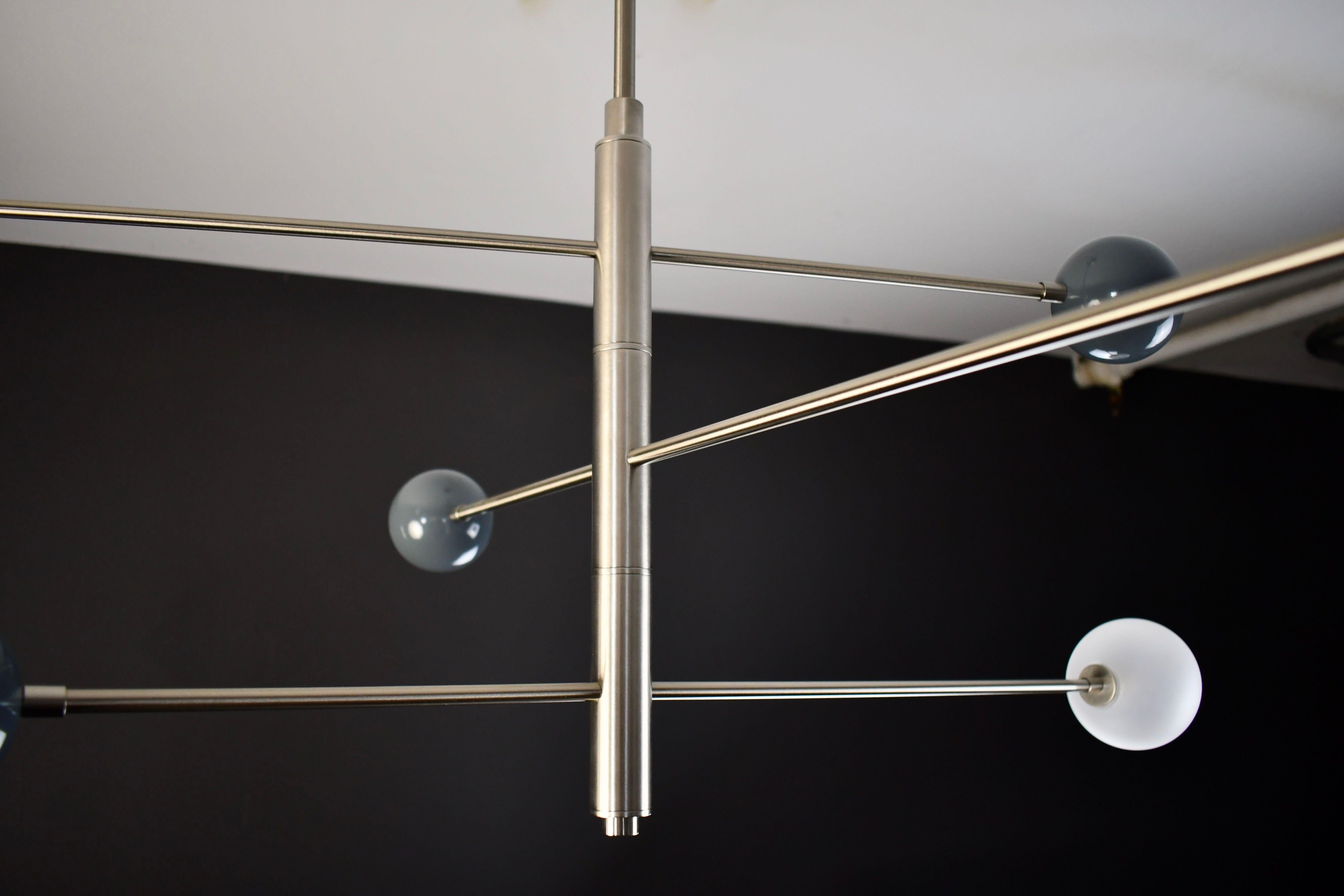 Handcrafted in NYC by Blueprint Lighting, our 'Orbital' Chandelier is a commanding statement piece with design elements of both Italian and French modernism as well as Hollywood Glam and is a stunning study in mixed materials.
All arms of this