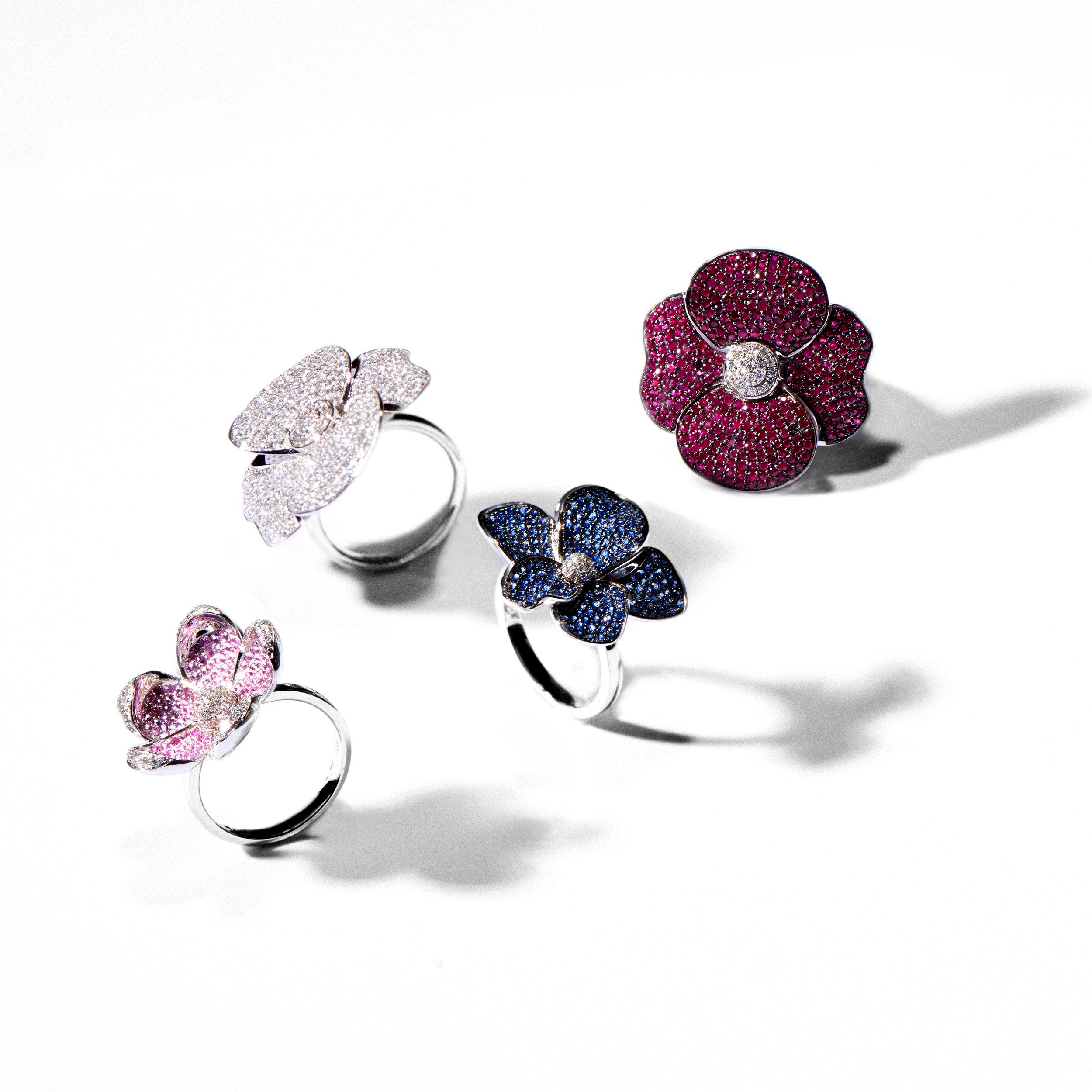Inspired by the graceful form of an orchid, this cocktail ring features a dazzling array of brilliant blue sapphires that create an eye-catching play of light and reflection. Five asymmetrical petals of blue sapphires surround a central circle of