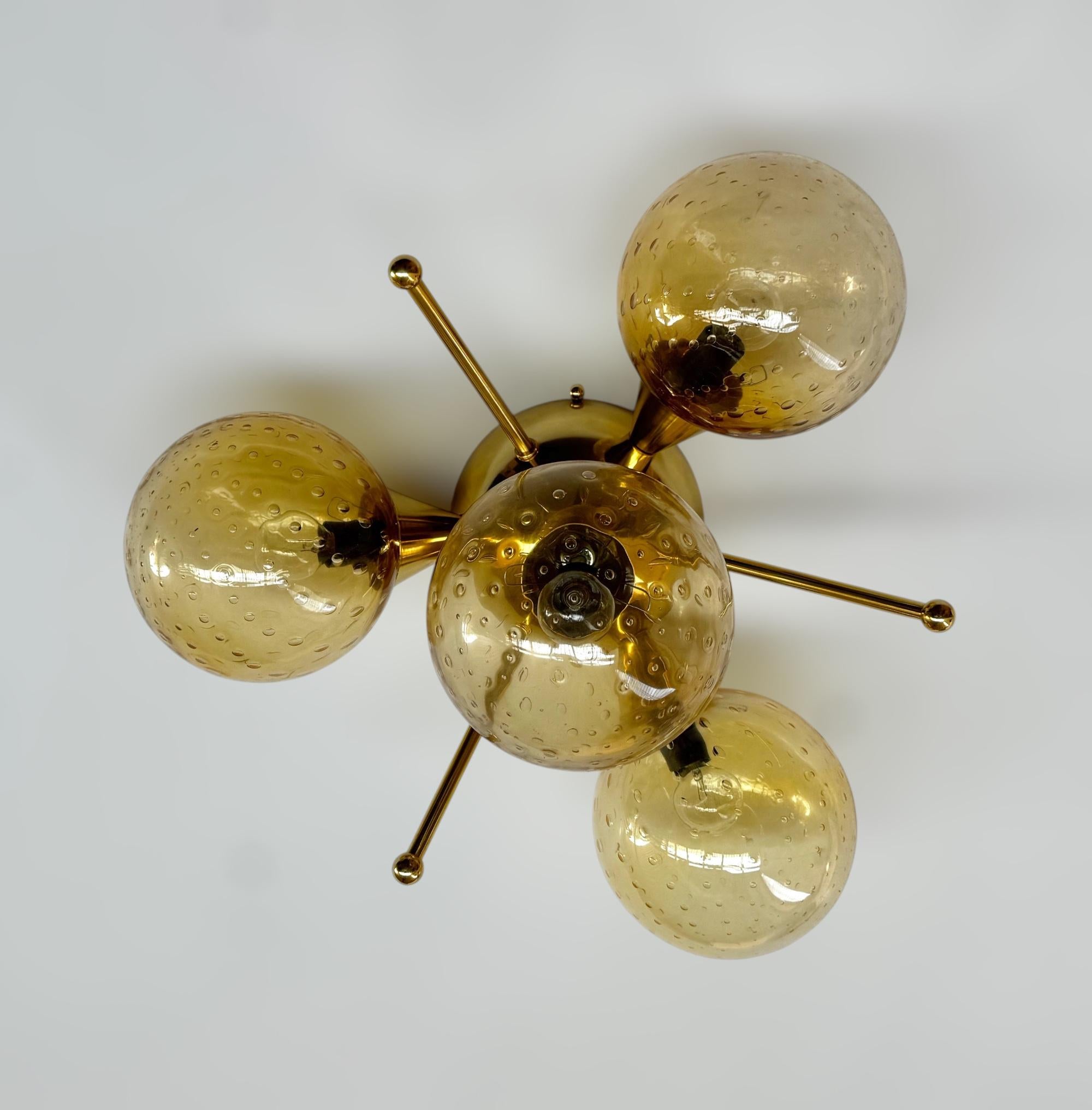 Italian flush mount with 4 Murano glass globes mounted on solid brass frame in lacquered polished brass finish
Designed by Fabio Bergomi / Made in Italy
4 lights / E12 or E14 type / max 40W each
Diameter: `18 inches / Height: 10 inches
Order only /