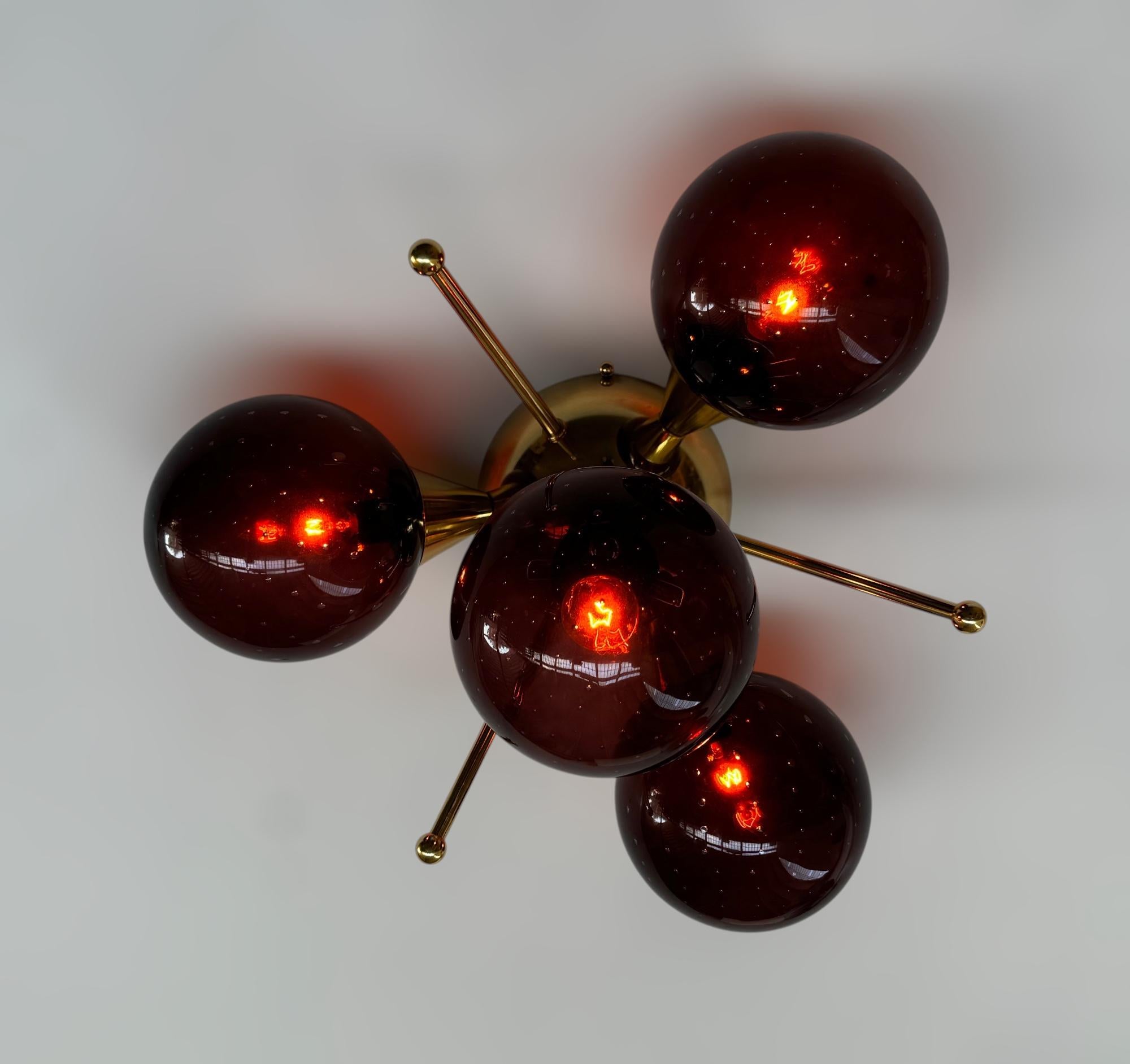 Italian flush mount with 4 Murano glass globes mounted on solid brass frame in lacquered polished brass finish
Designed by Fabio Bergomi / Made in Italy
4 lights / E12 or E14 type / max 40W each
Diameter: `18 inches / Height: 10 inches
Order only /
