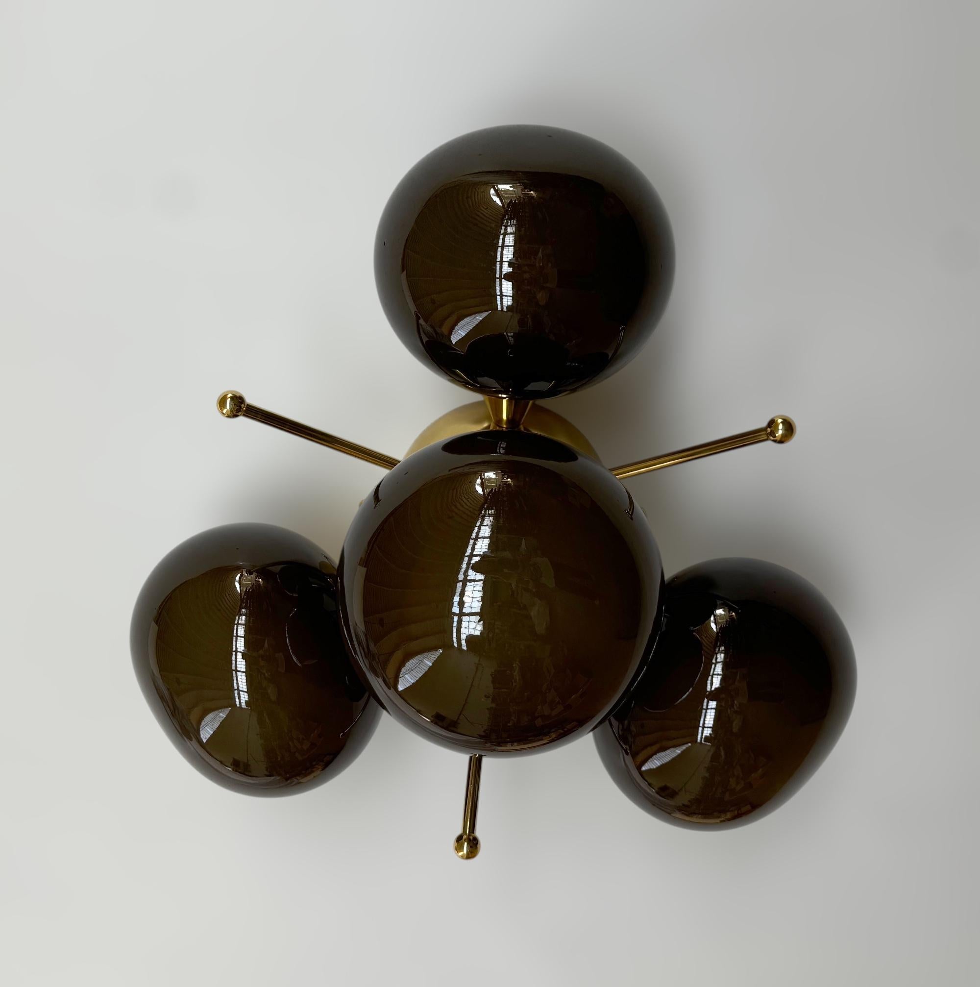Italian flush mount with 4 pebble shaped Murano glass shades mounted on solid brass frame in lacquered polished brass finish
Designed by Fabio Bergomi / Made in Italy
4 lights / E12 or E14 type / max 40W each
Diameter: `20 inches / Height: 10.5